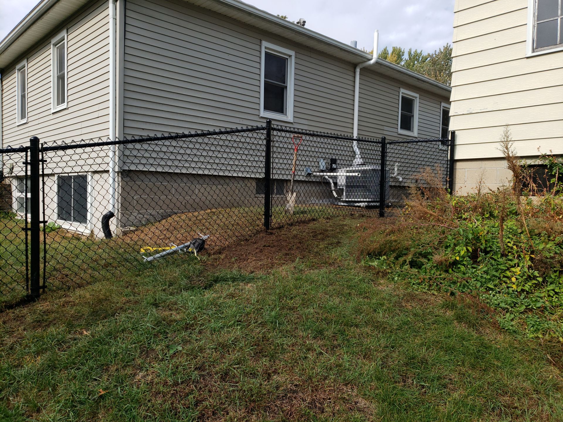 Residential Black Vinyl-Coated Chain Link Fence in Waterloo by Perfect Picket Fence and Stain