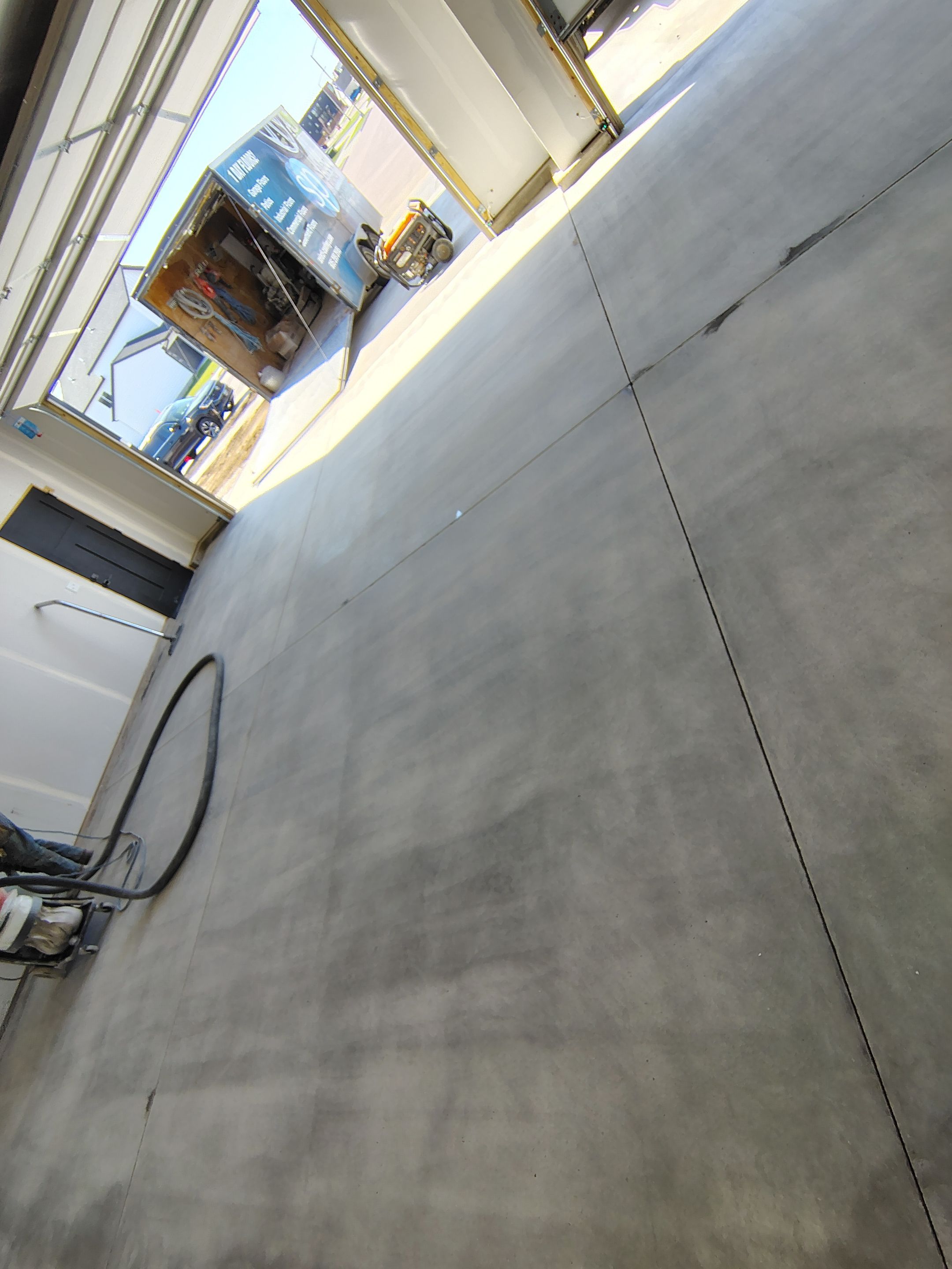 Speckled Epoxy Garage Floor Coating Installation in Sioux Falls by Select Painting, Coatings & Garage Cabinets