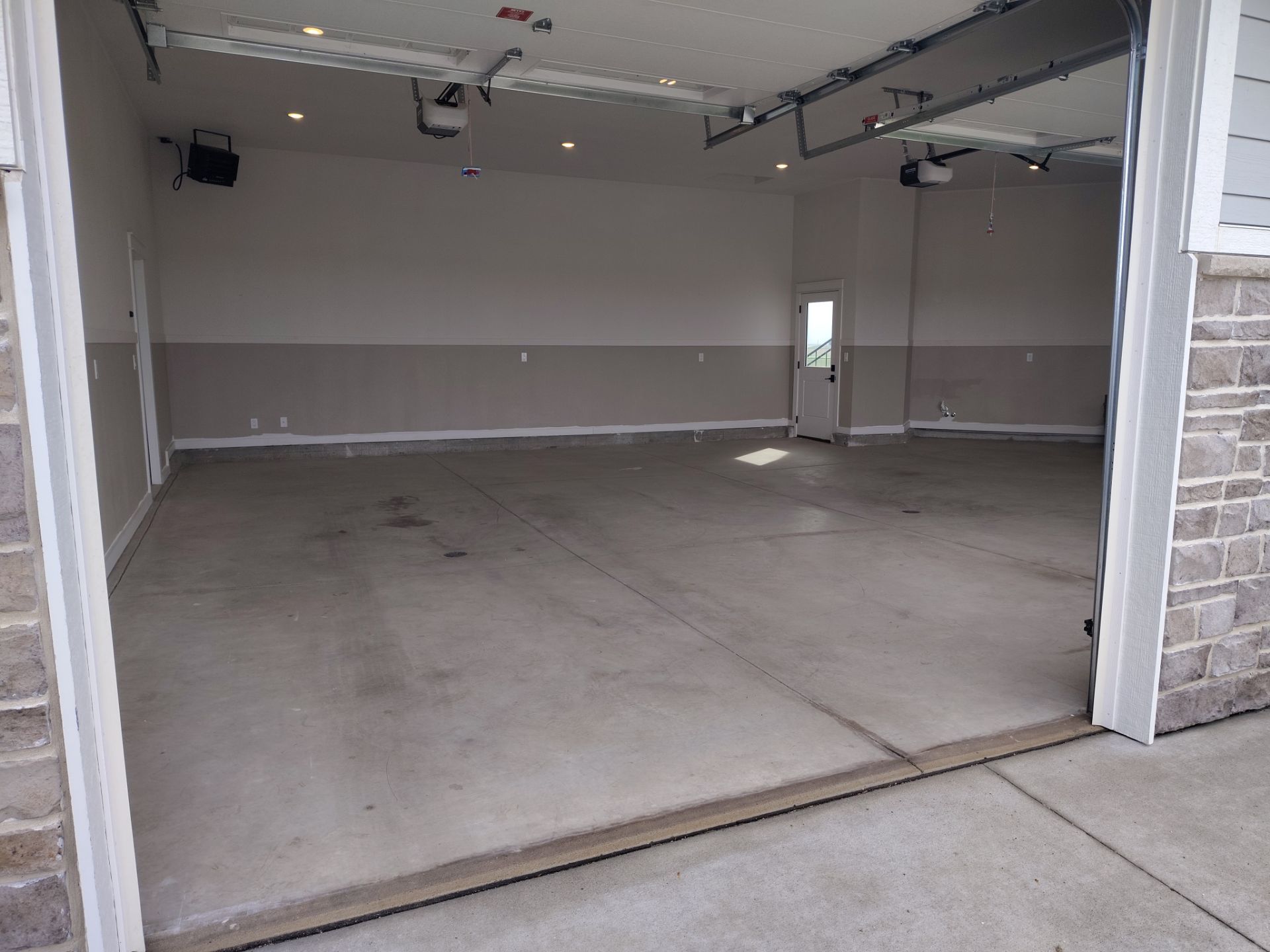 Ames Garage Floor Transformation with Gray and White Speckled Epoxy by Revival Concrete Coatings