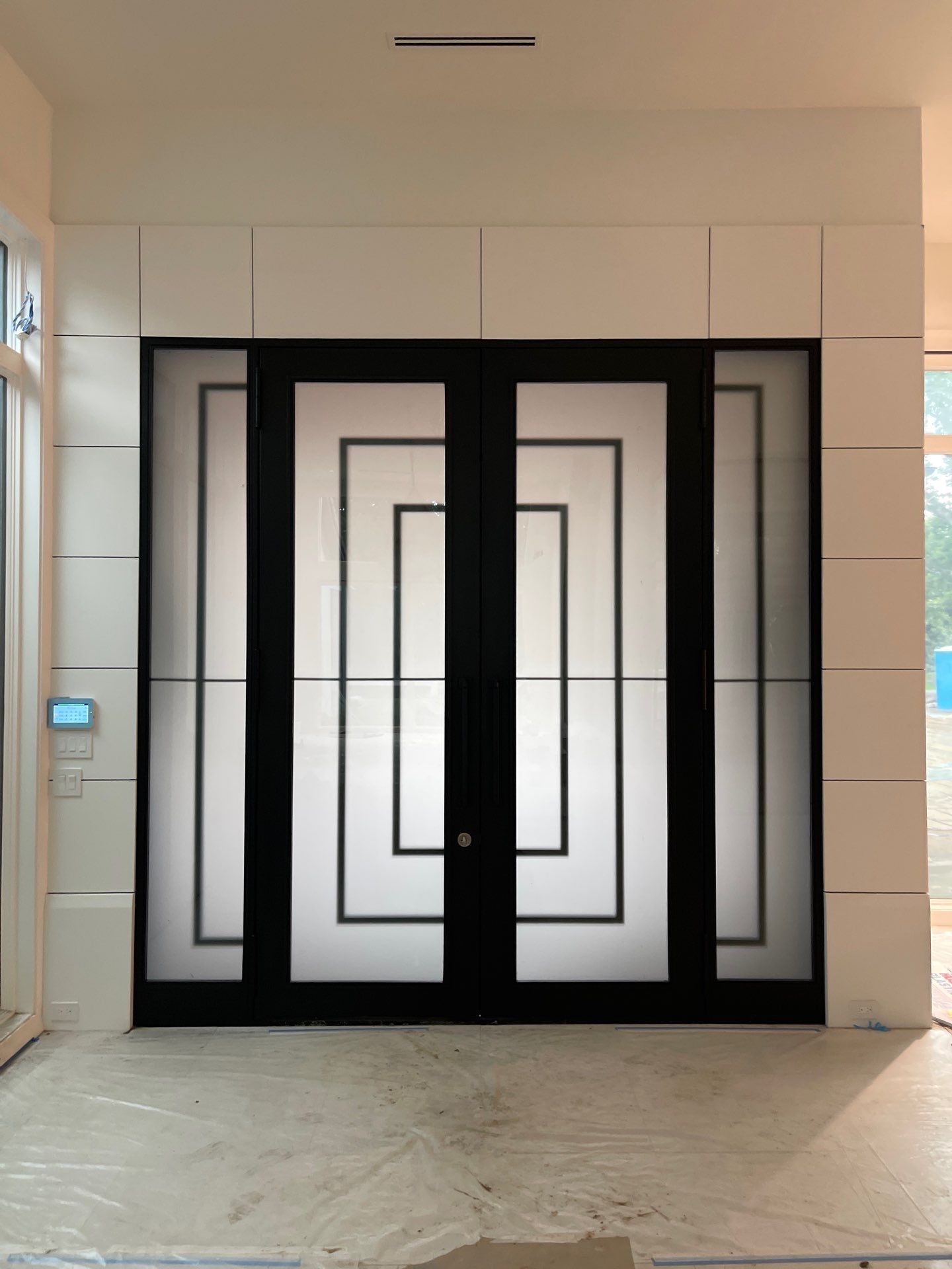 Modern Metal and Glass Entryway Installation with Custom Hardware Finishing in Dallas by Solara Custom Living