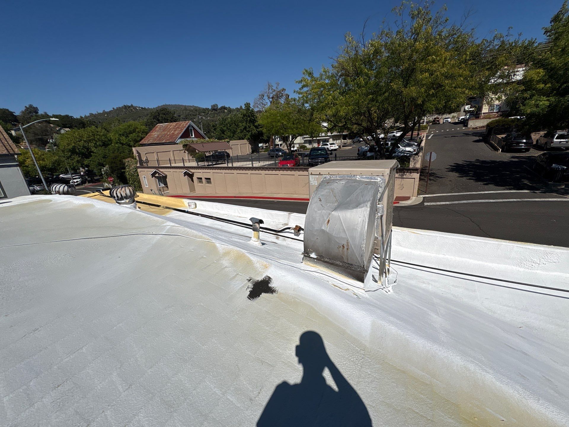 Foam and coatings on commercial roof by Straight Edge Roofing Inc