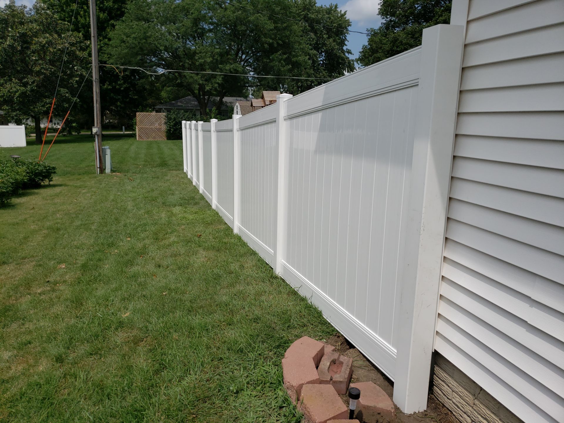 White Vinyl Privacy Fence Installation in Grundy Center by Perfect Picket Fence and Stain