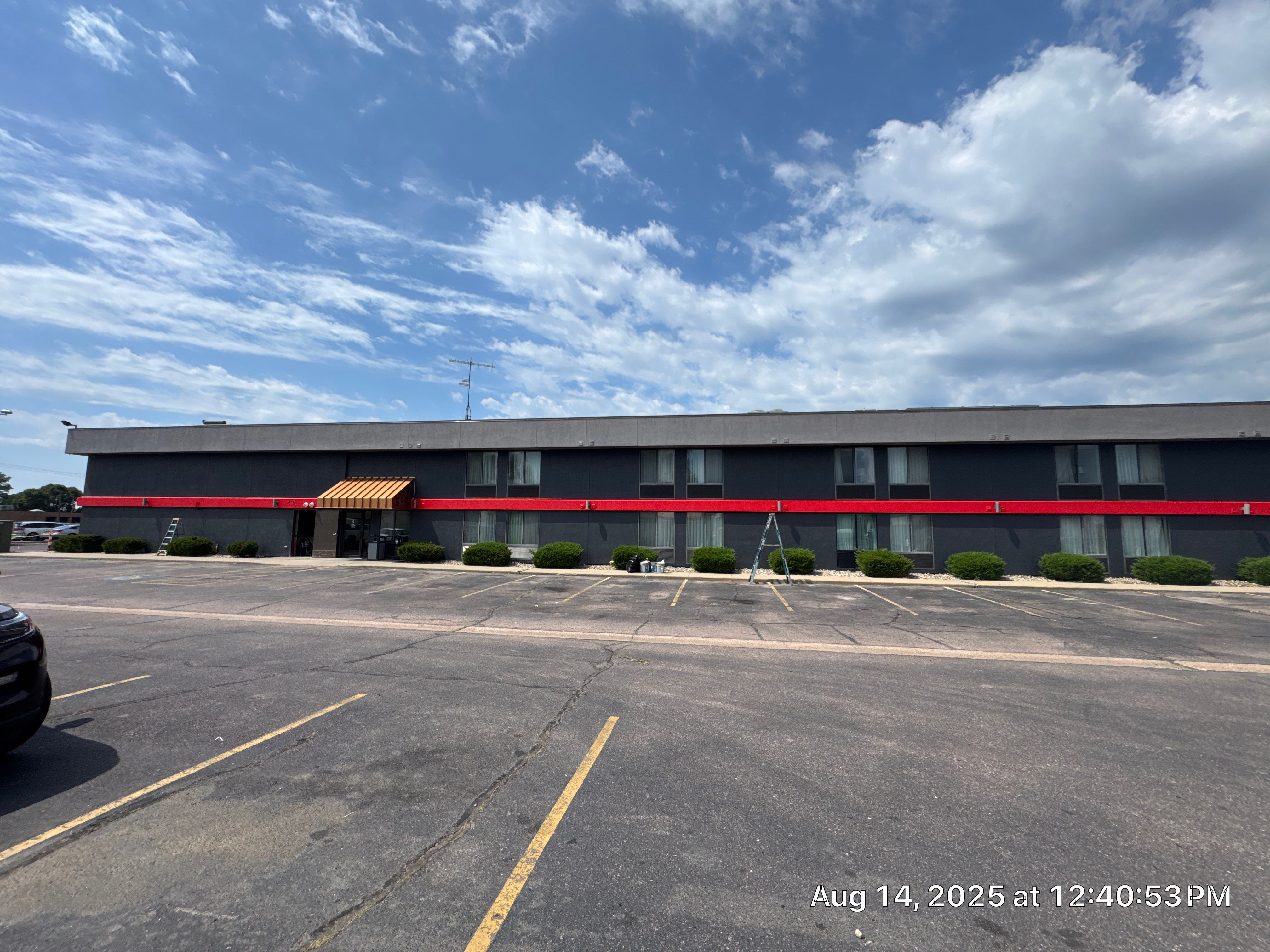 Commercial Exterior Painting with Stucco and Bold Red Accent Trim by Select Painting, Coatings & Garage Cabinets