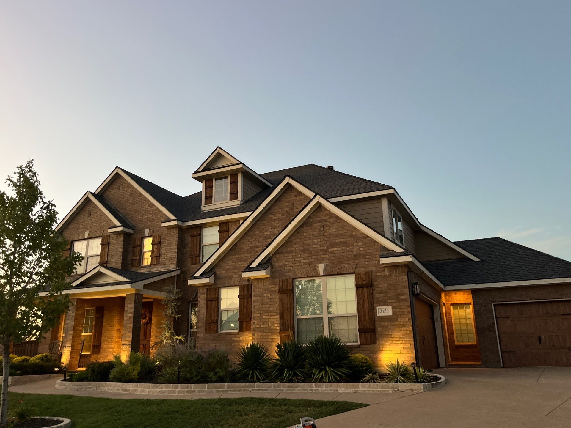 Medium brown brick with GAF Pewter Gray  by Tejas Roofworks + Restoration