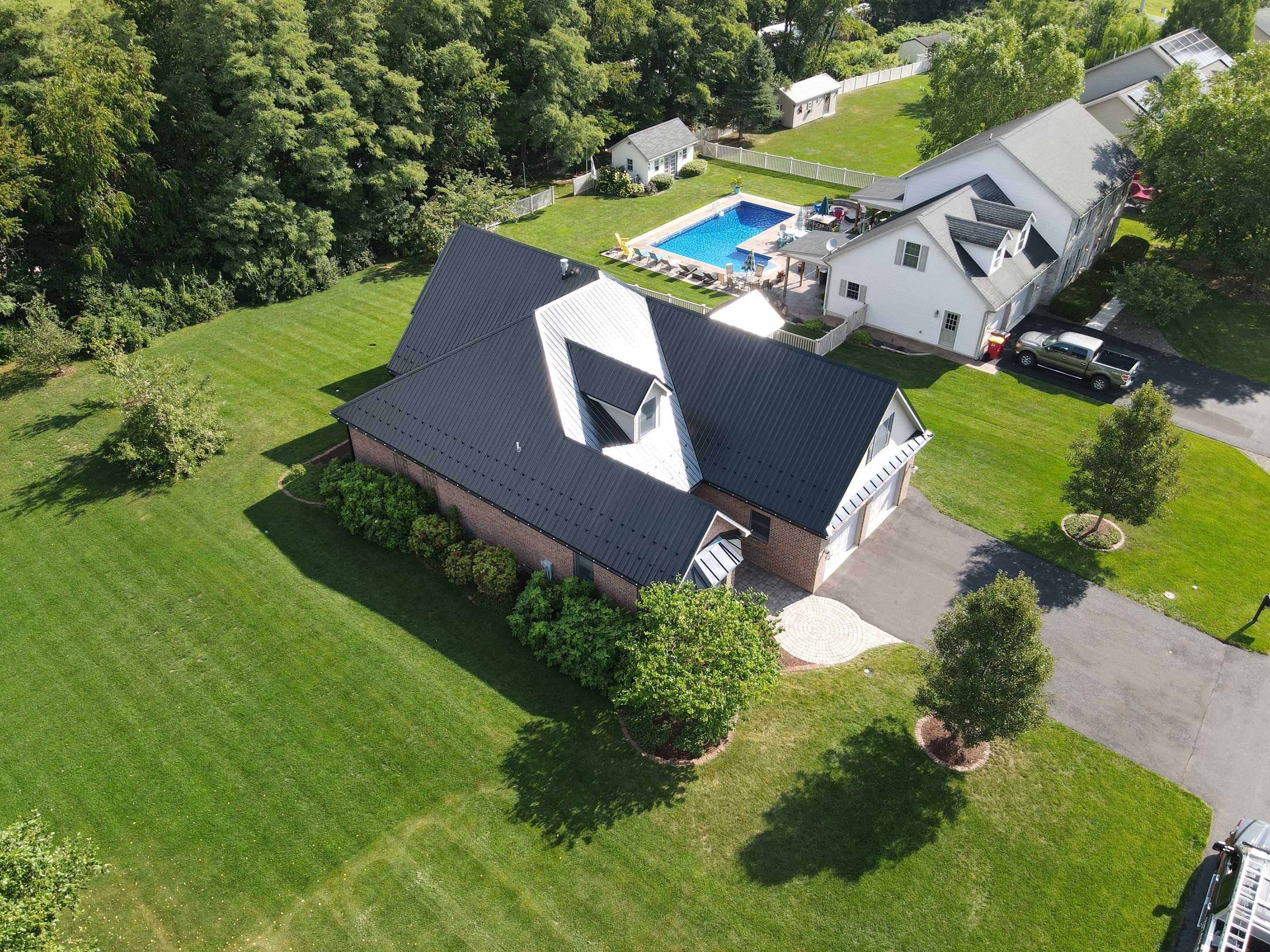 Standing seam / Azm panel in black  by Teflon Roofing