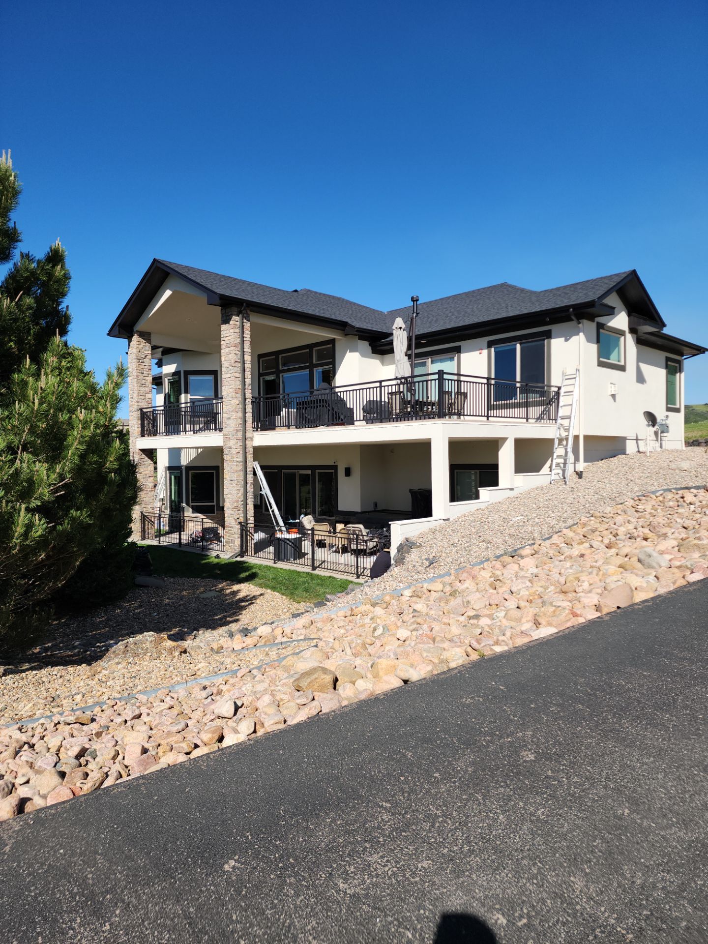 Castle Rock Elegance: White Stucco Exterior with Bold Tricorn Black by J&M Painting LLC