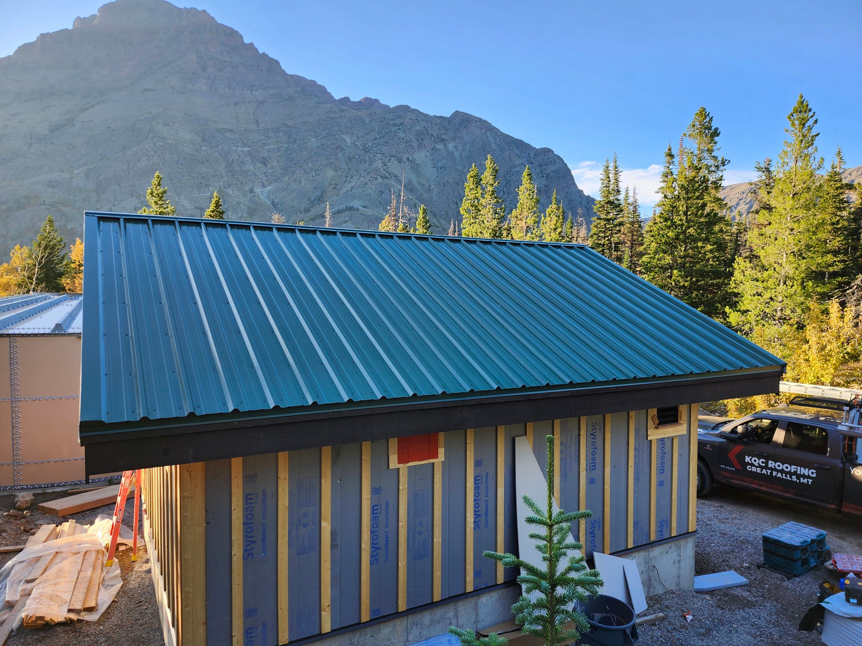 Green Standing Seam Metal Roof Installation in East Glacier Park by KQC Roofing