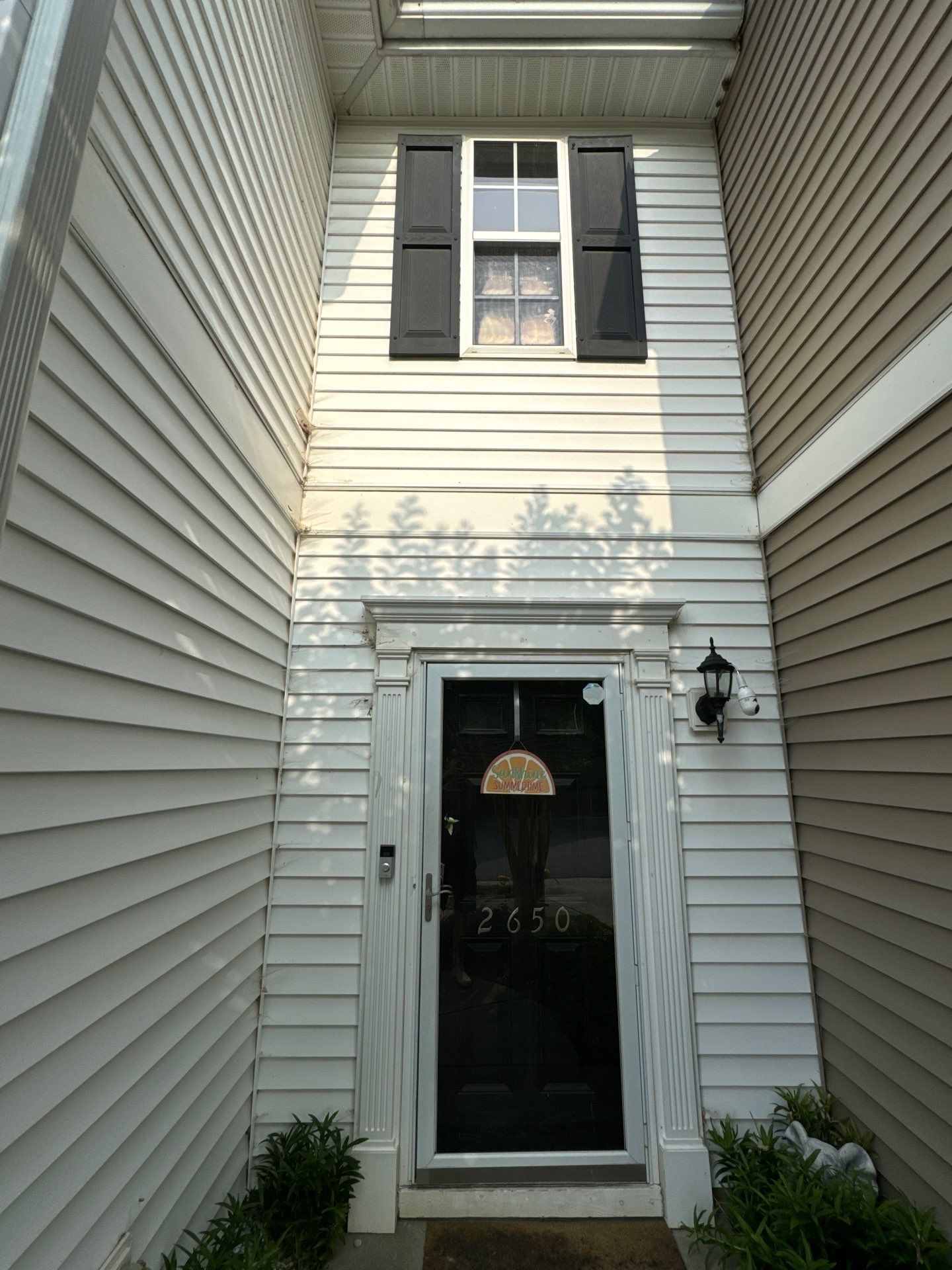 pressure washing exterior siding and entryway for cleaning and maintenance