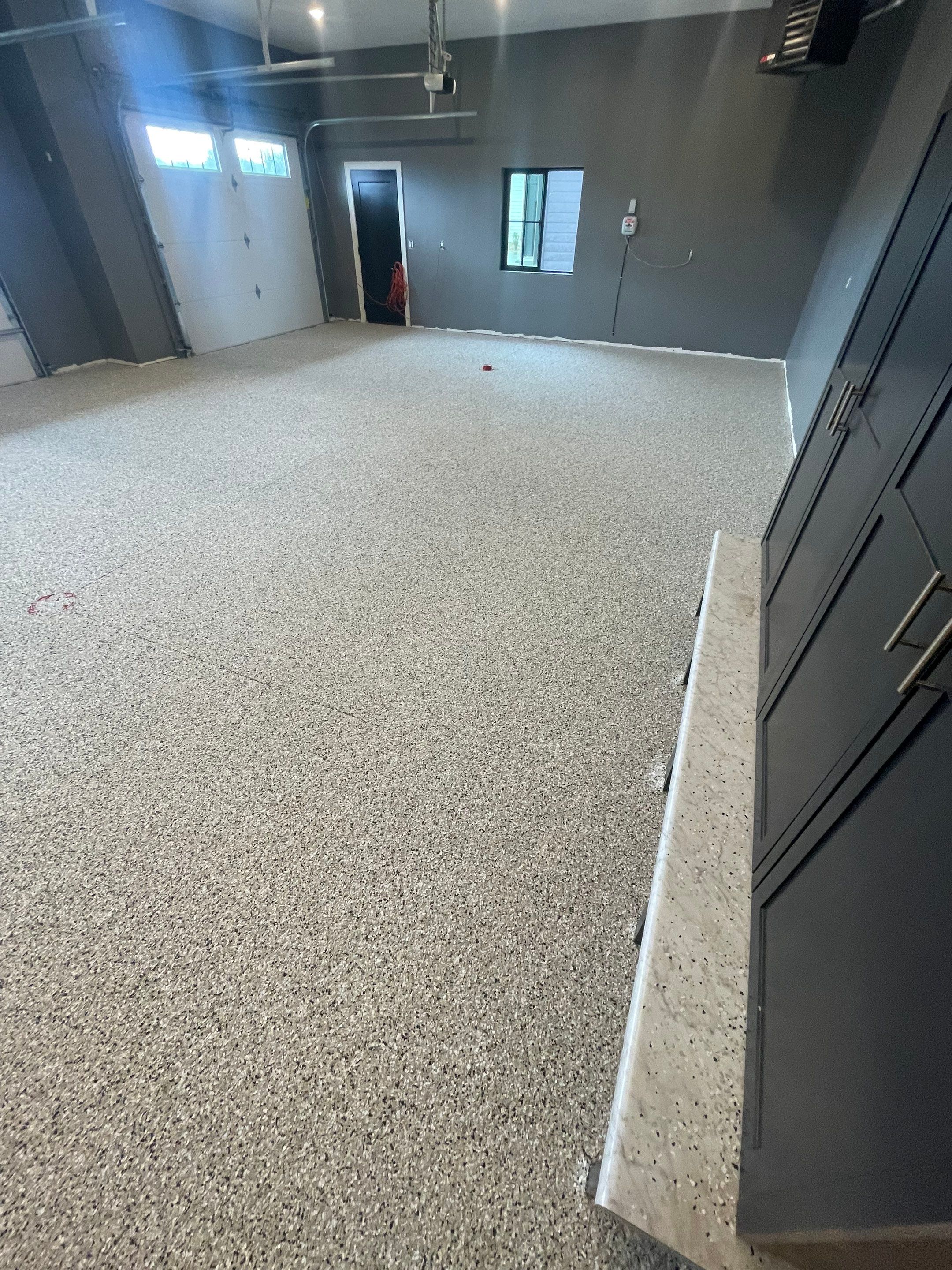 Custom Speckled Concrete Coating for Dell Rapids Garage by Select Painting, Coatings & Garage Cabinets