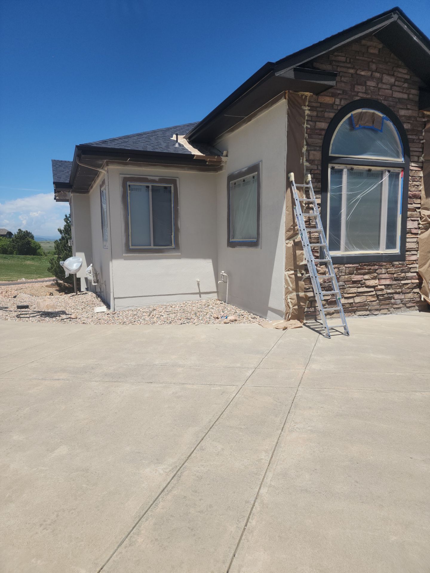 Castle Rock Elegance: White Stucco Exterior with Bold Tricorn Black by J&M Painting LLC