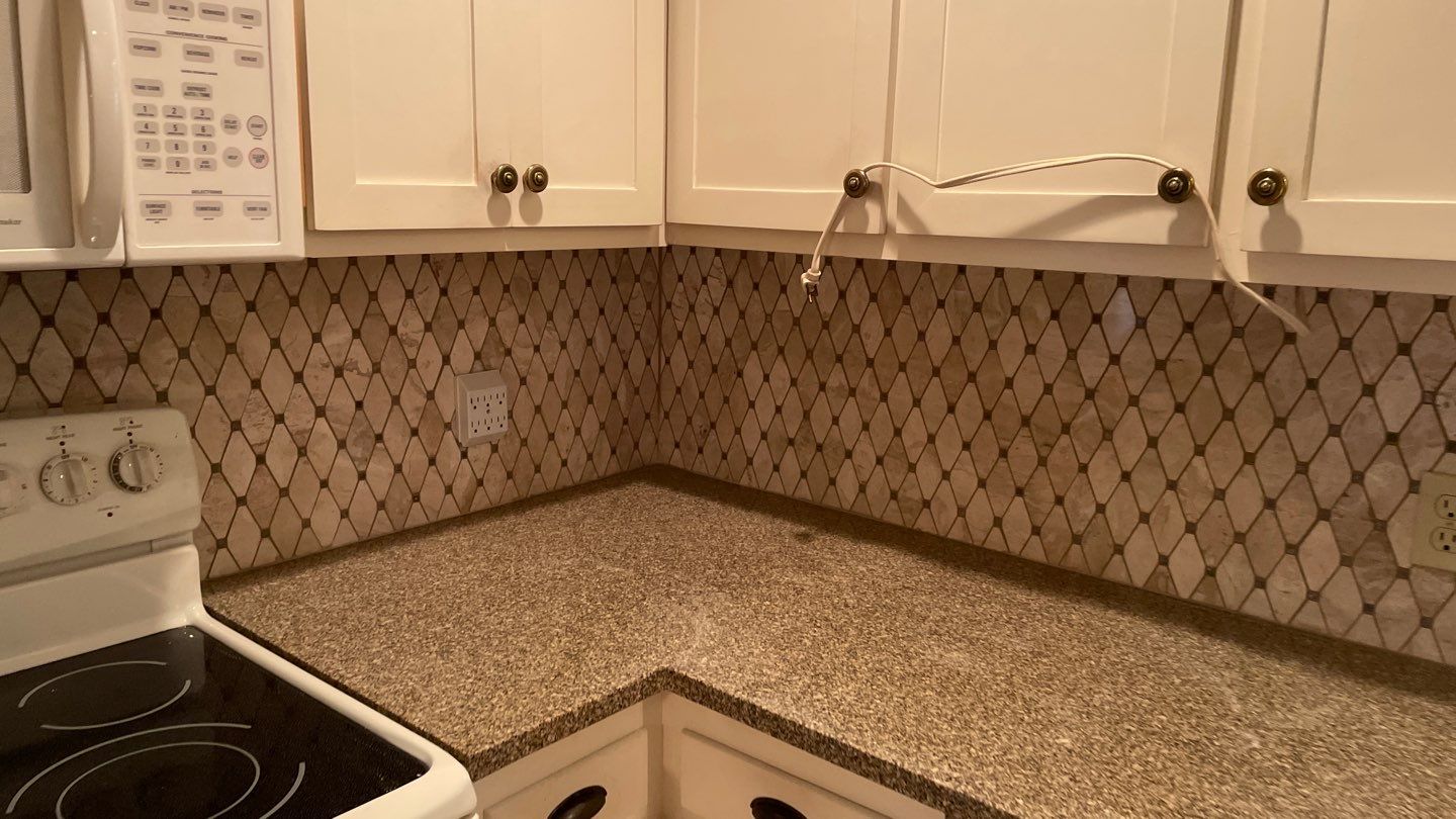 New Backsplash to Compliment the Countertops by Footprints Floors of Coastal Carolina