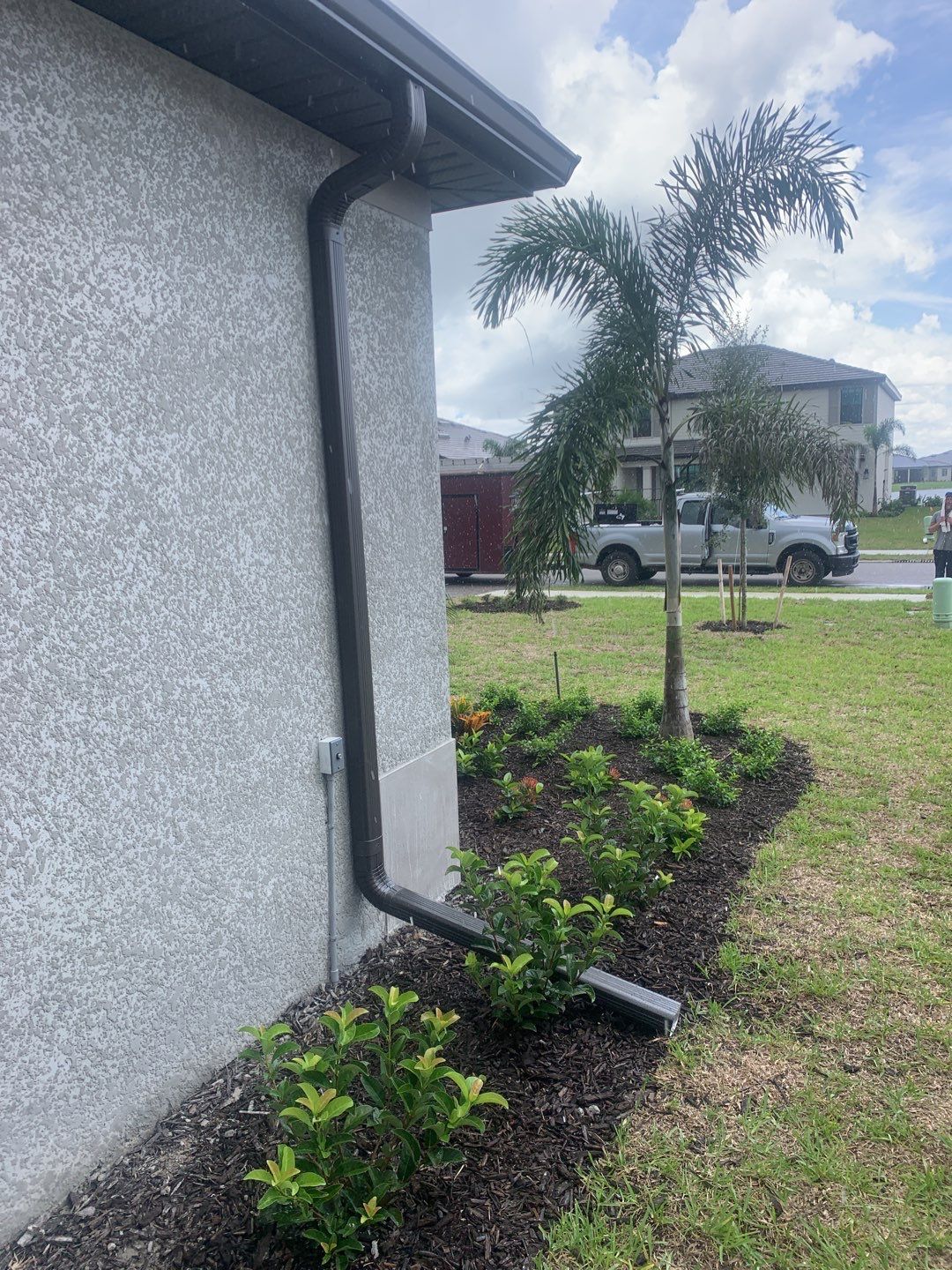 Seamless brown gutter and downspouts installation in Estero, FL  by Gutter Professors