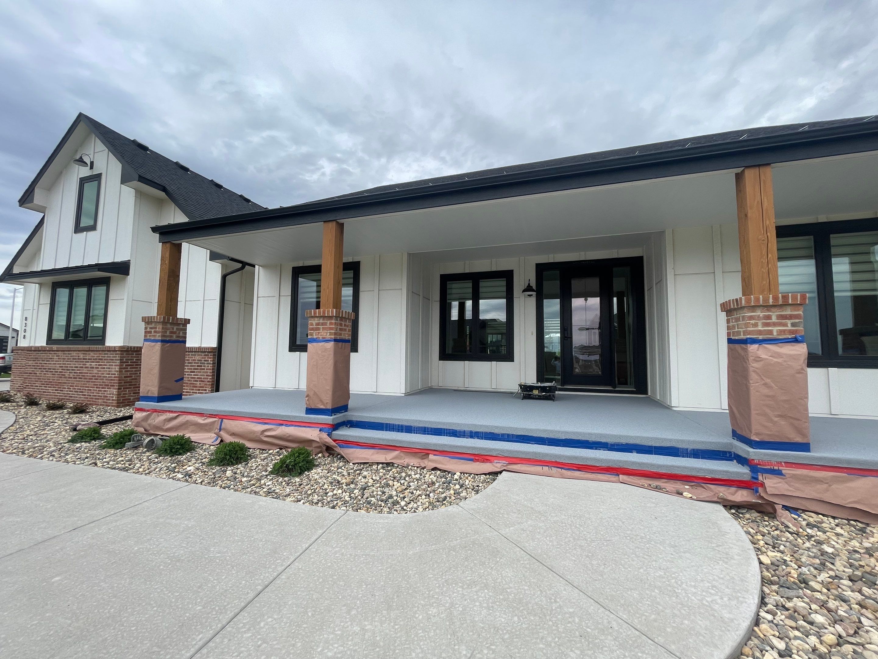 Grey Speckled Concrete Porch Coating for Sioux Falls Home by Select Painting, Coatings & Garage Cabinets