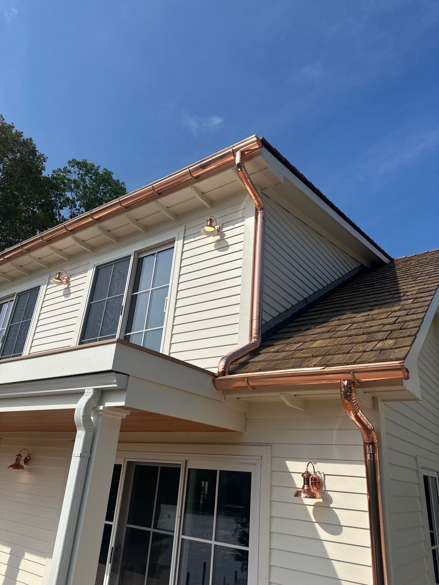 Custom Copper Gutter System and Accent Roofing in East Jordan by Rainbow Seamless Systems