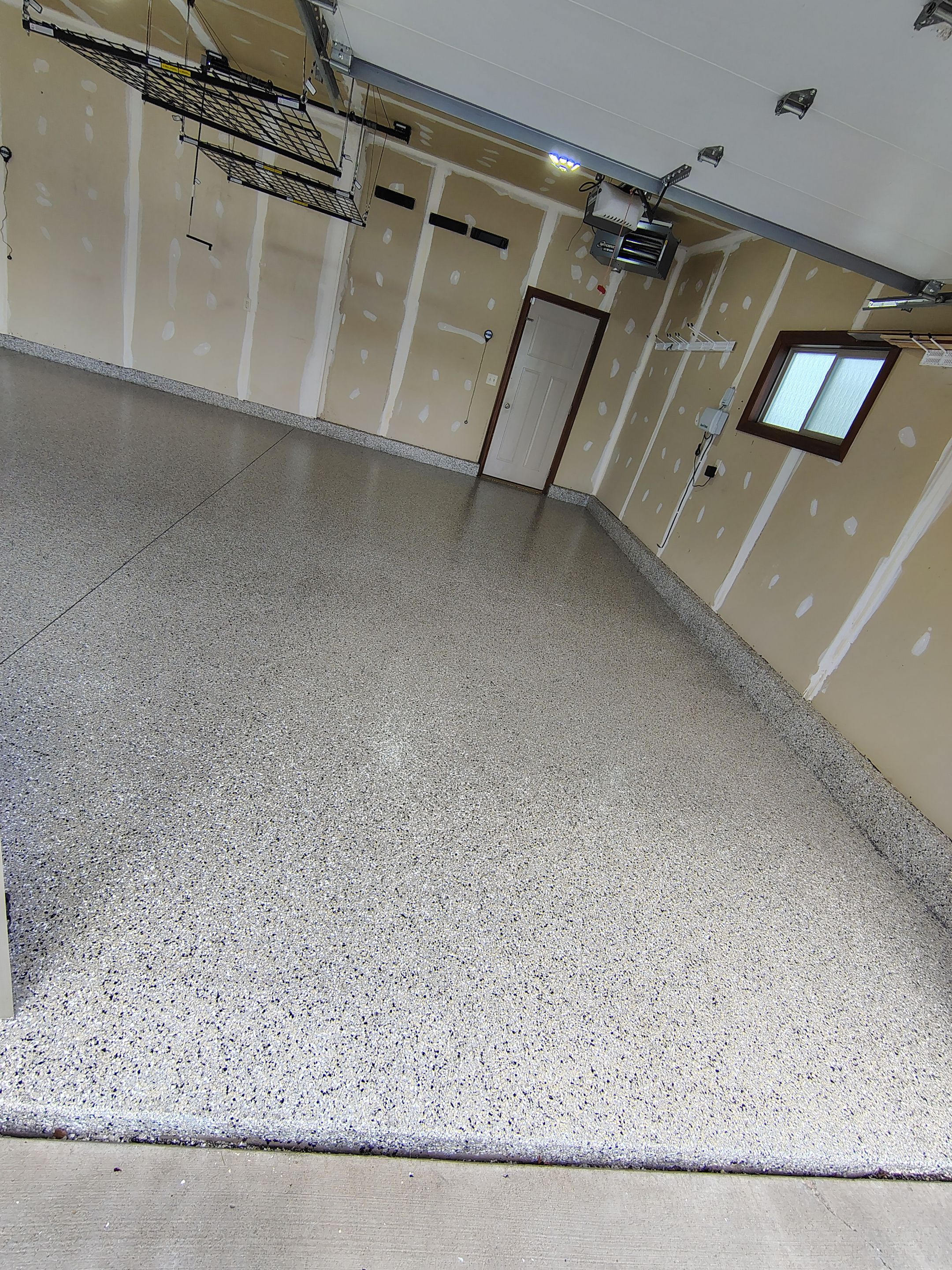 Multi-Car Garage Concrete Coating and Epoxy Finish in Sioux Falls by Select Painting, Coatings & Garage Cabinets
