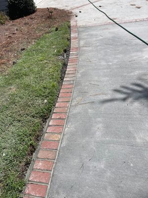 Concrete Driveway Cleaning and Restoration With Decorative Red Brick Border
