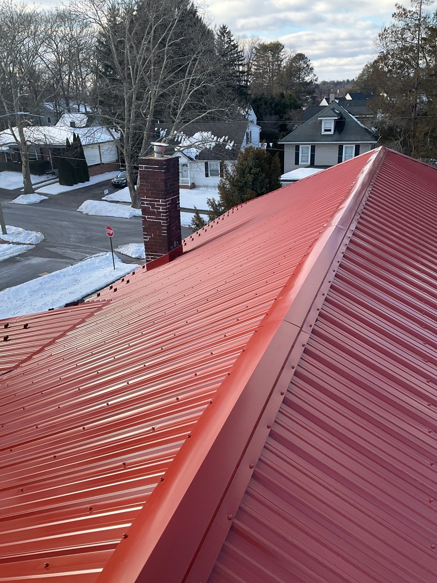 Red Metal Roofing Upgrade for Brick Home by Esh Builders