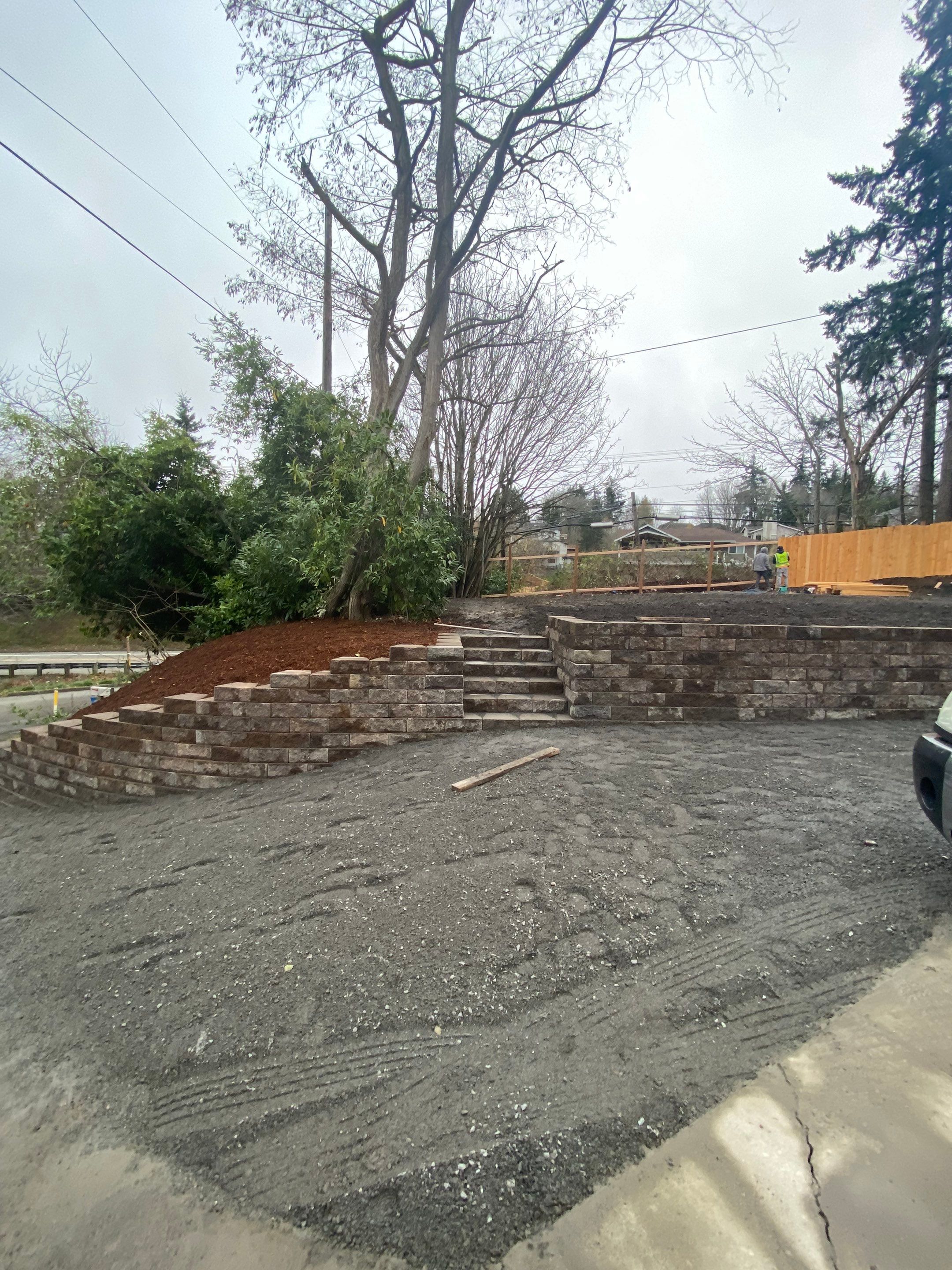 Patio Installation using Concrete, Retaining walls, and Turf install by Jireh Asphalt & Concrete Inc 