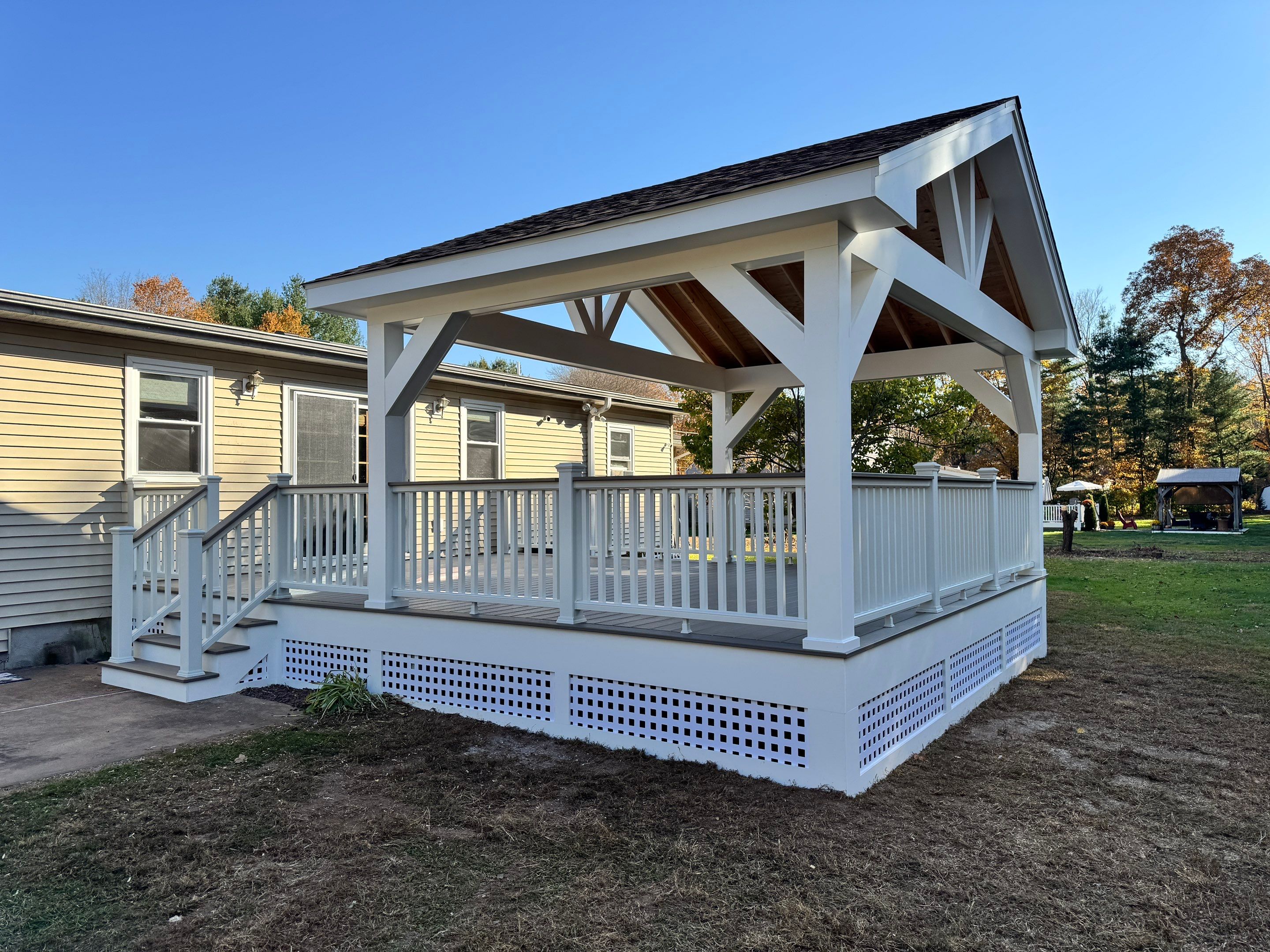 Replacement deck and Roof overhang. Trex Lineage Biscayne boards and matching cocktail rail.  by DiGiorgi Roofing and Siding Inc