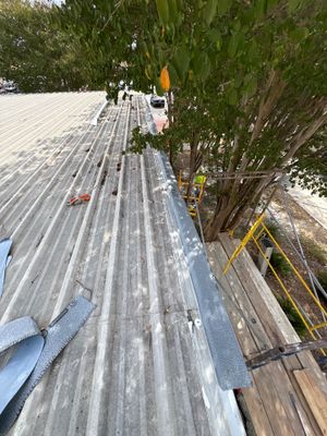 Scaffolding next to corrugated metal roof edge