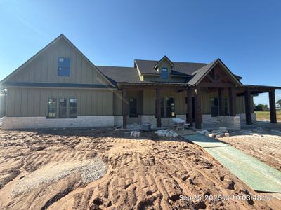 Cleveland Ranch Charm: Natural Stone Wainscot with Green Accent Siding.