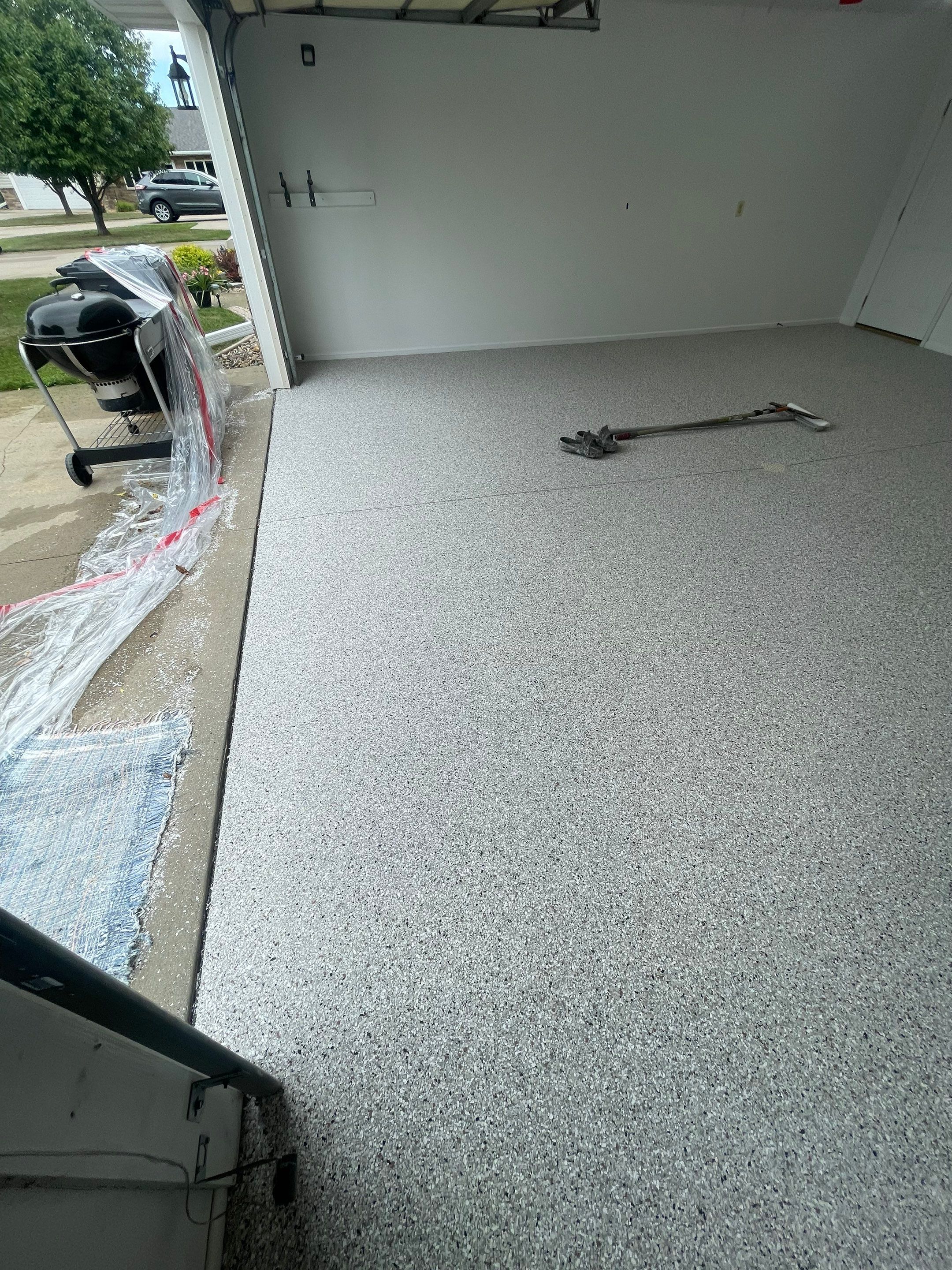 Coyote Flake Garage Floor Coating in Worthington, Minnesota by Select Painting, Coatings & Garage Cabinets