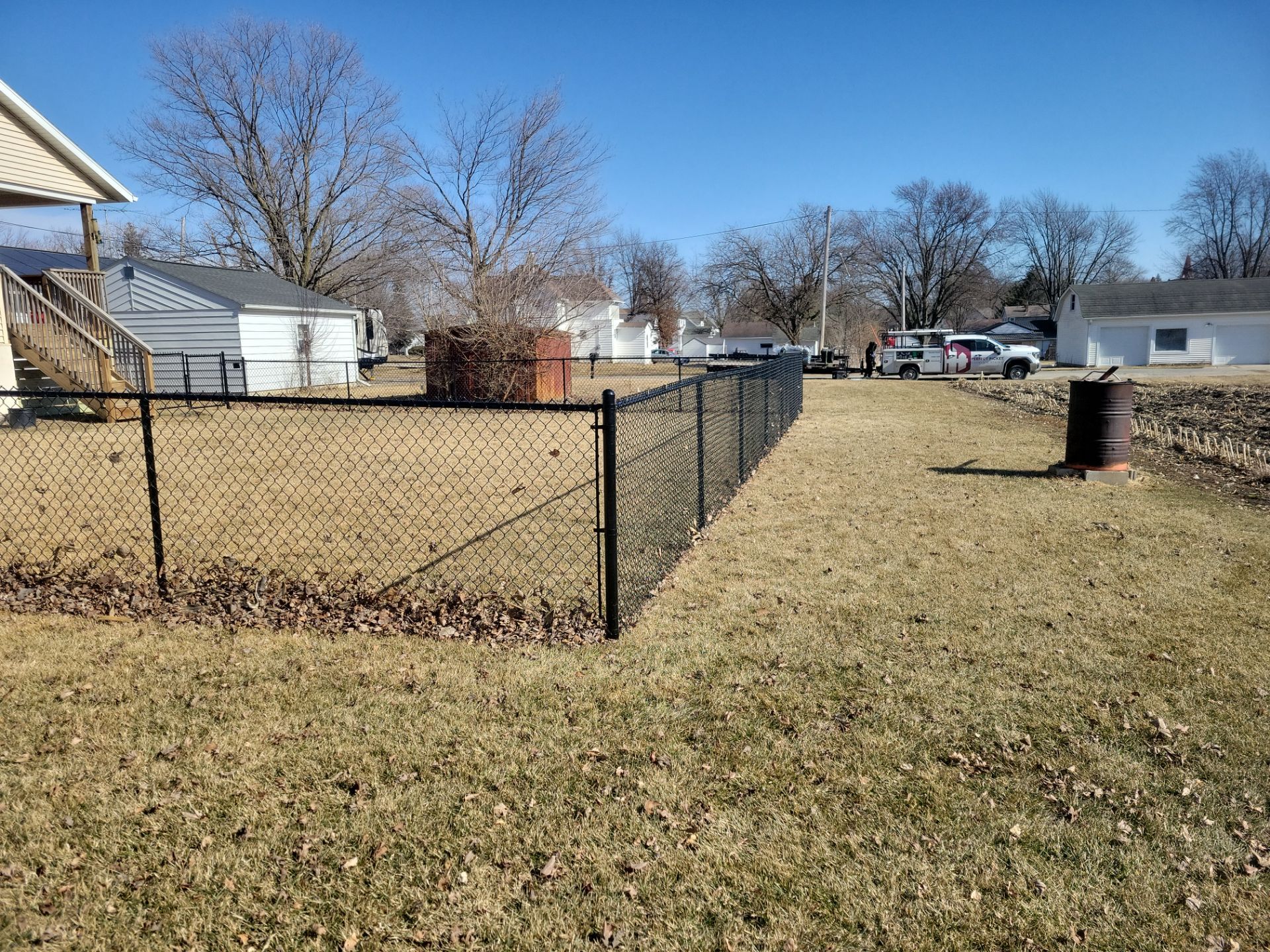 Residential Black Chain Link Fence and Gate Installation in Tripoli by Perfect Picket Fence and Stain