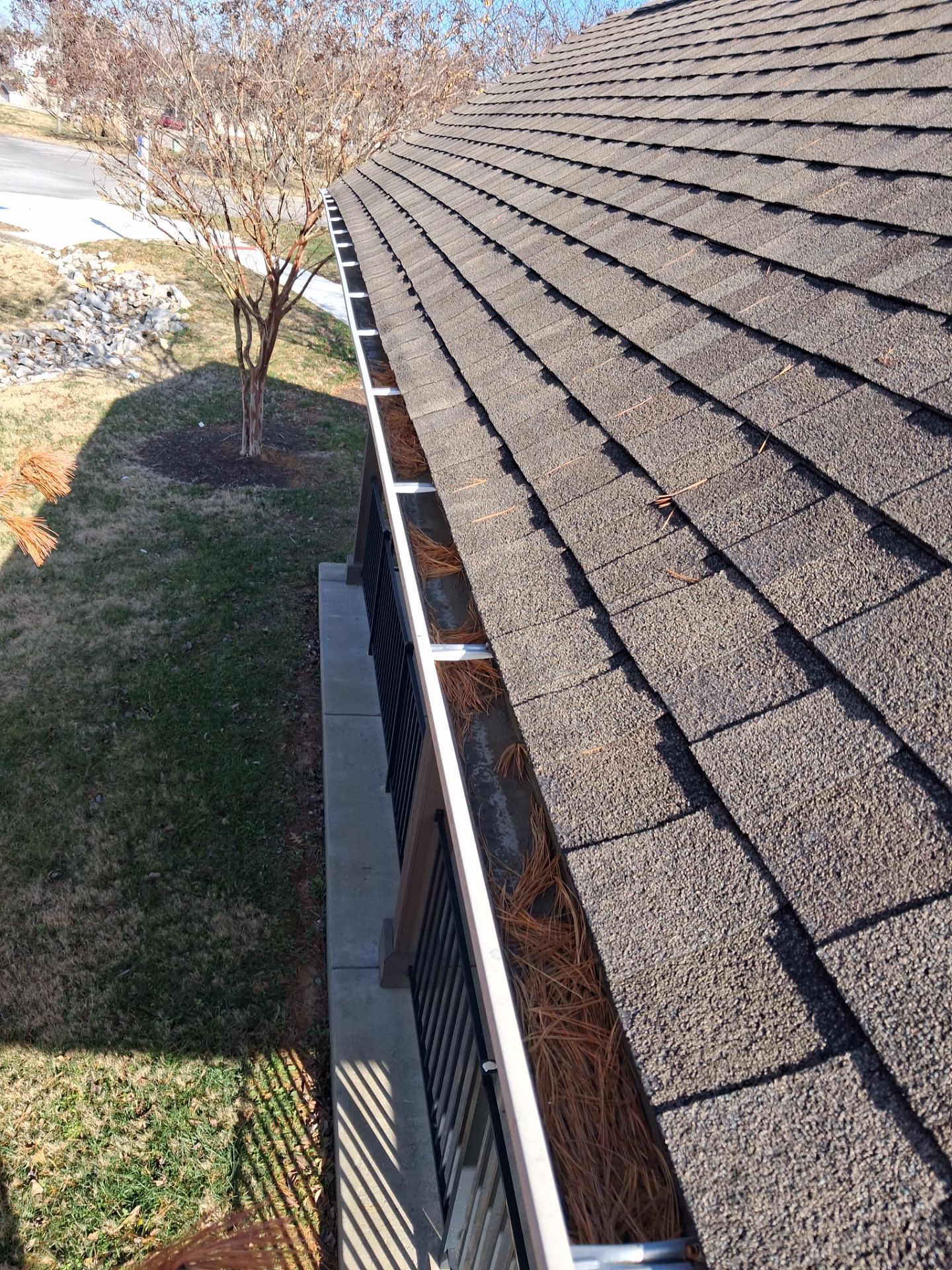 Commercial gutter cleaning Spring Hill, TN before photo with filled gutters