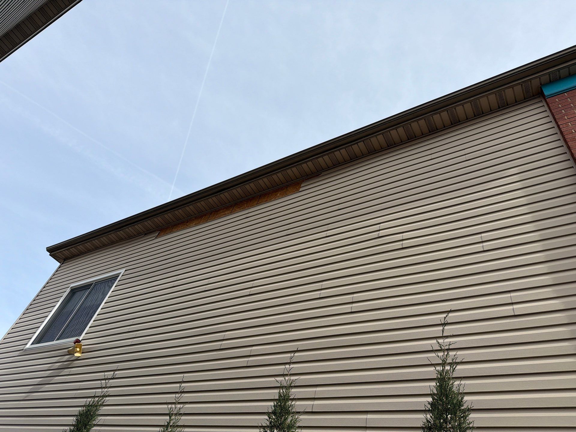 Mocha Lap Siding Installation for St. Louis Residential Exterior by Acute Roofing And Exteriors