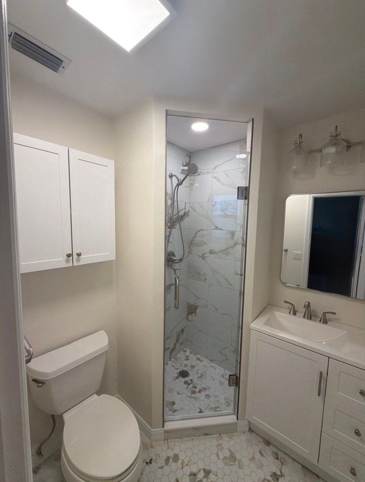 Modern Bathroom Remodel Featuring Marble Tile in Ormond Beach by Acies Renovations