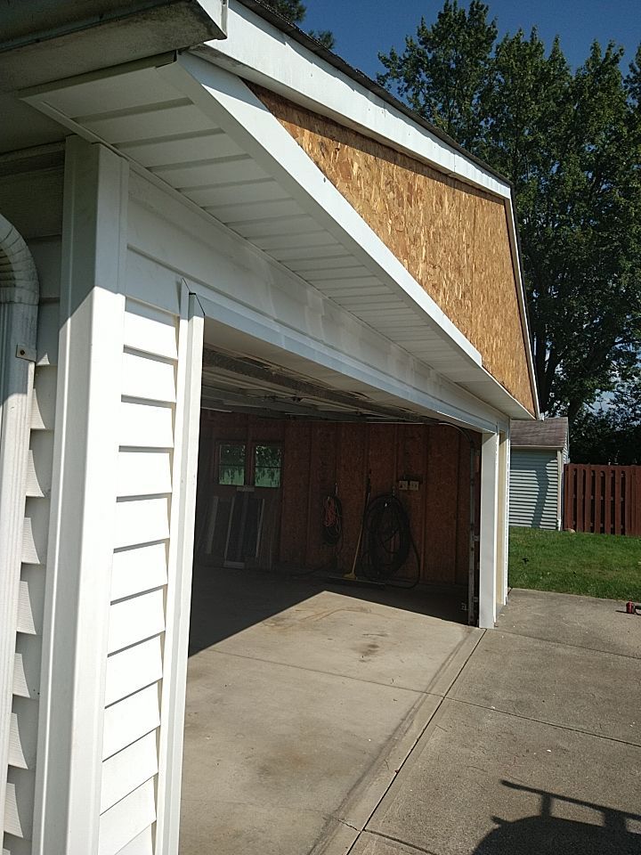 Siding Installation using Norandex woodsman dl-5 white woodgrain vinyl by Absolute Roofing and Construction