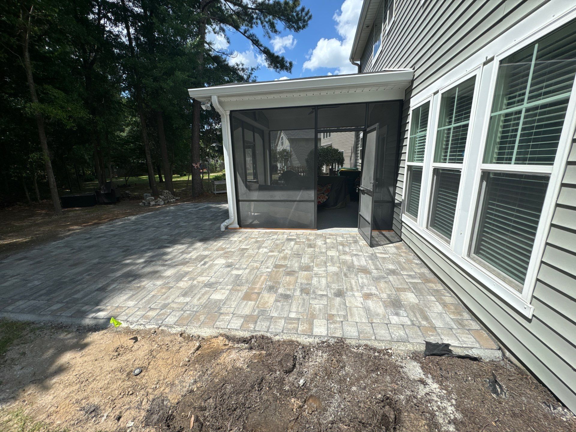 Custom Paver Patio Extension and Circular Fire Pit in Bluffton by Lowcountry Scapes, LLC