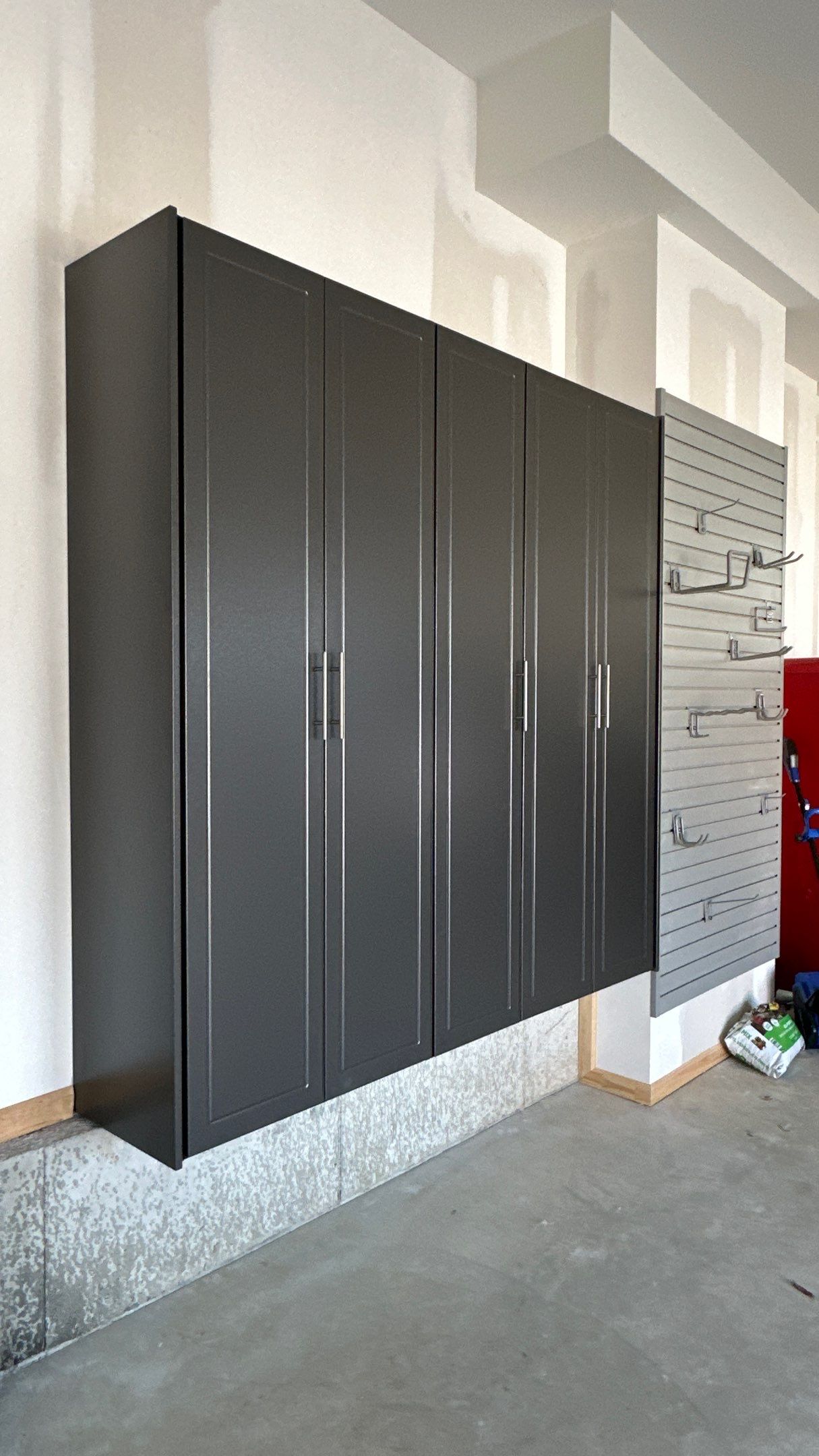 Megan J. added cabinets and slotwall to her garage. Plus a New Floor by Banner Garage