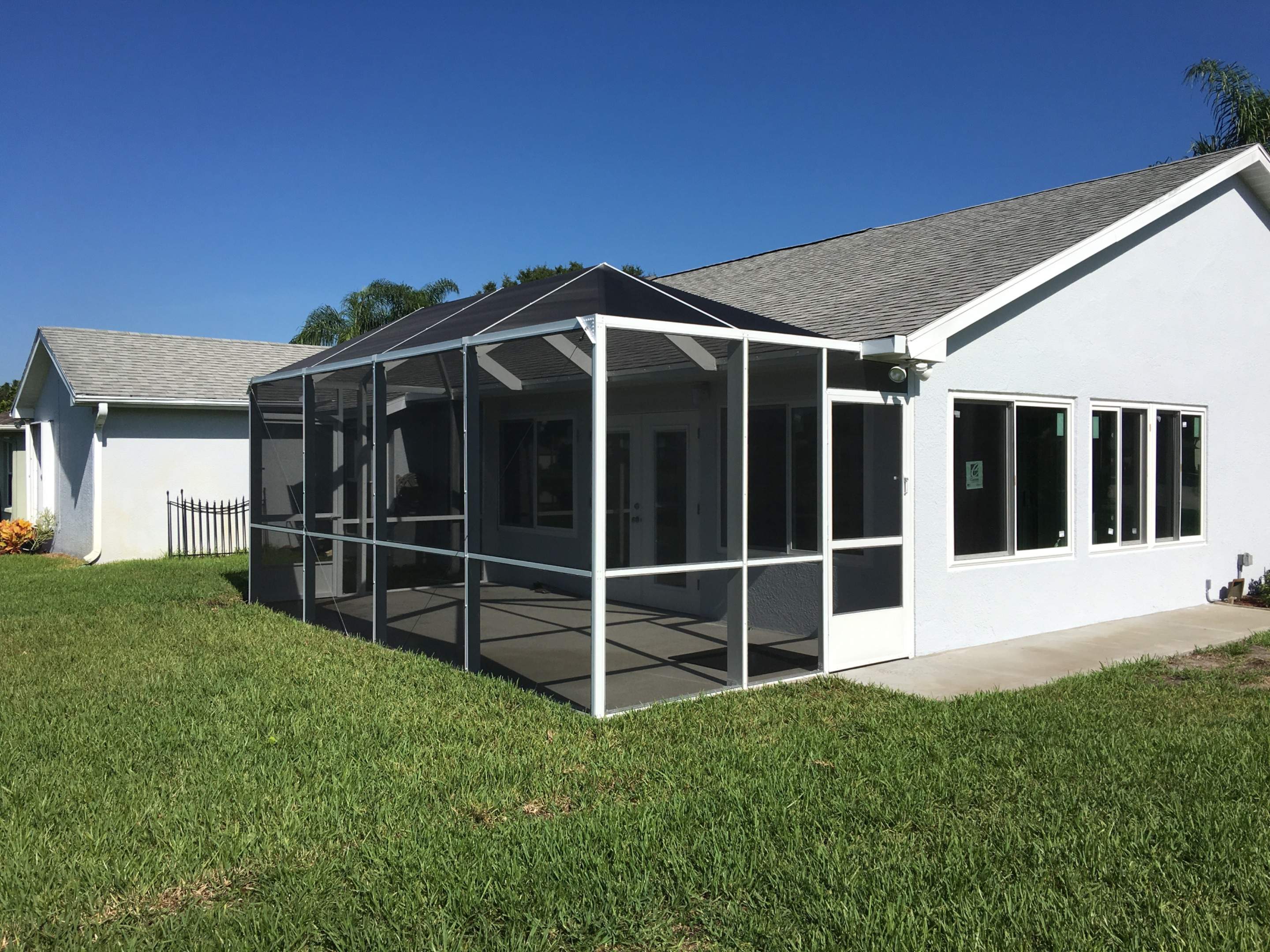 Screened Enclosure and Patio Addition for Melbourne Residence by Florida Roofing and Renovations Inc.