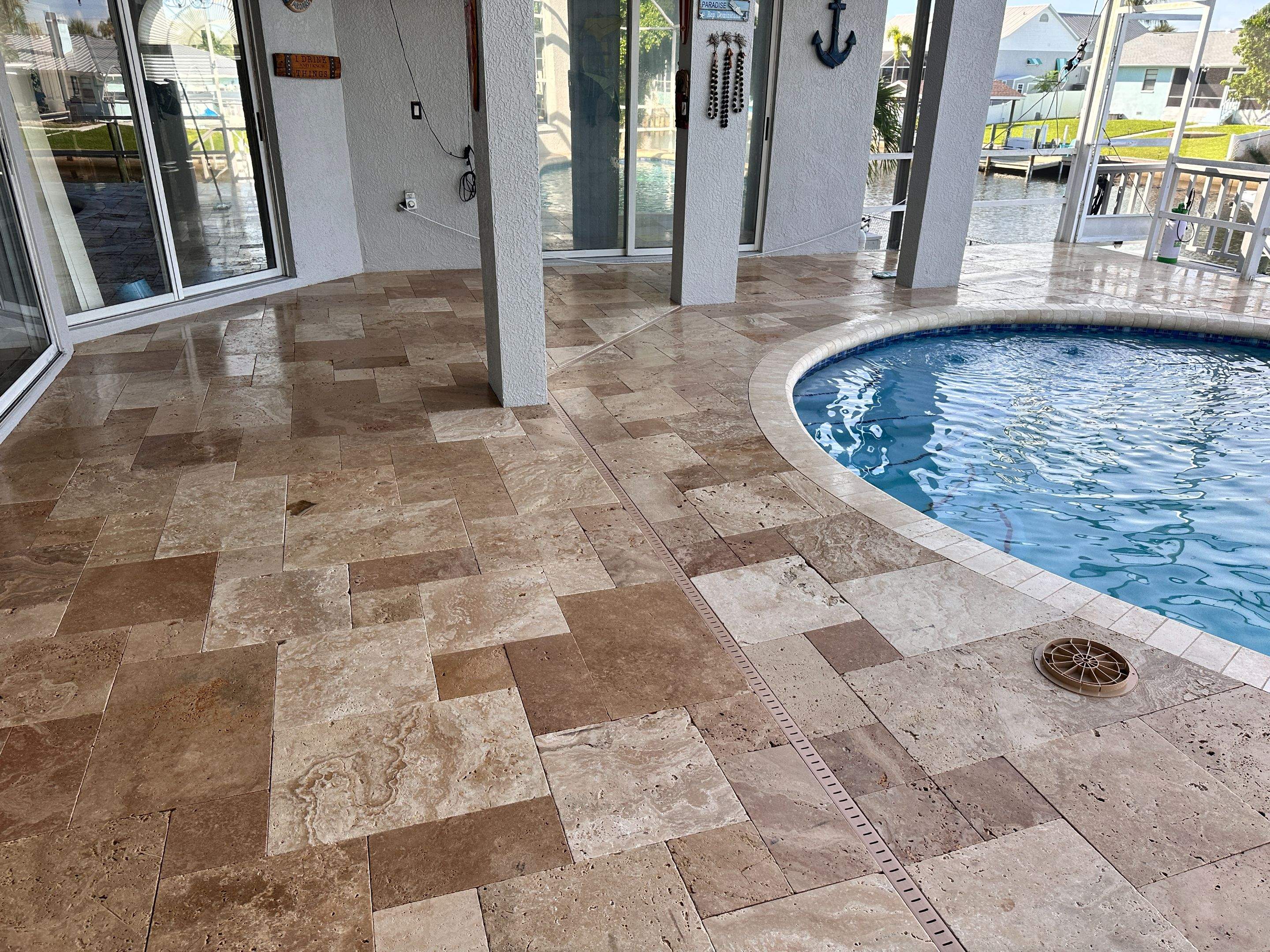 Travertine Sealing and Stripping for a Waterfront Pool Deck in Apollo Beach by Supreme Paver Experts