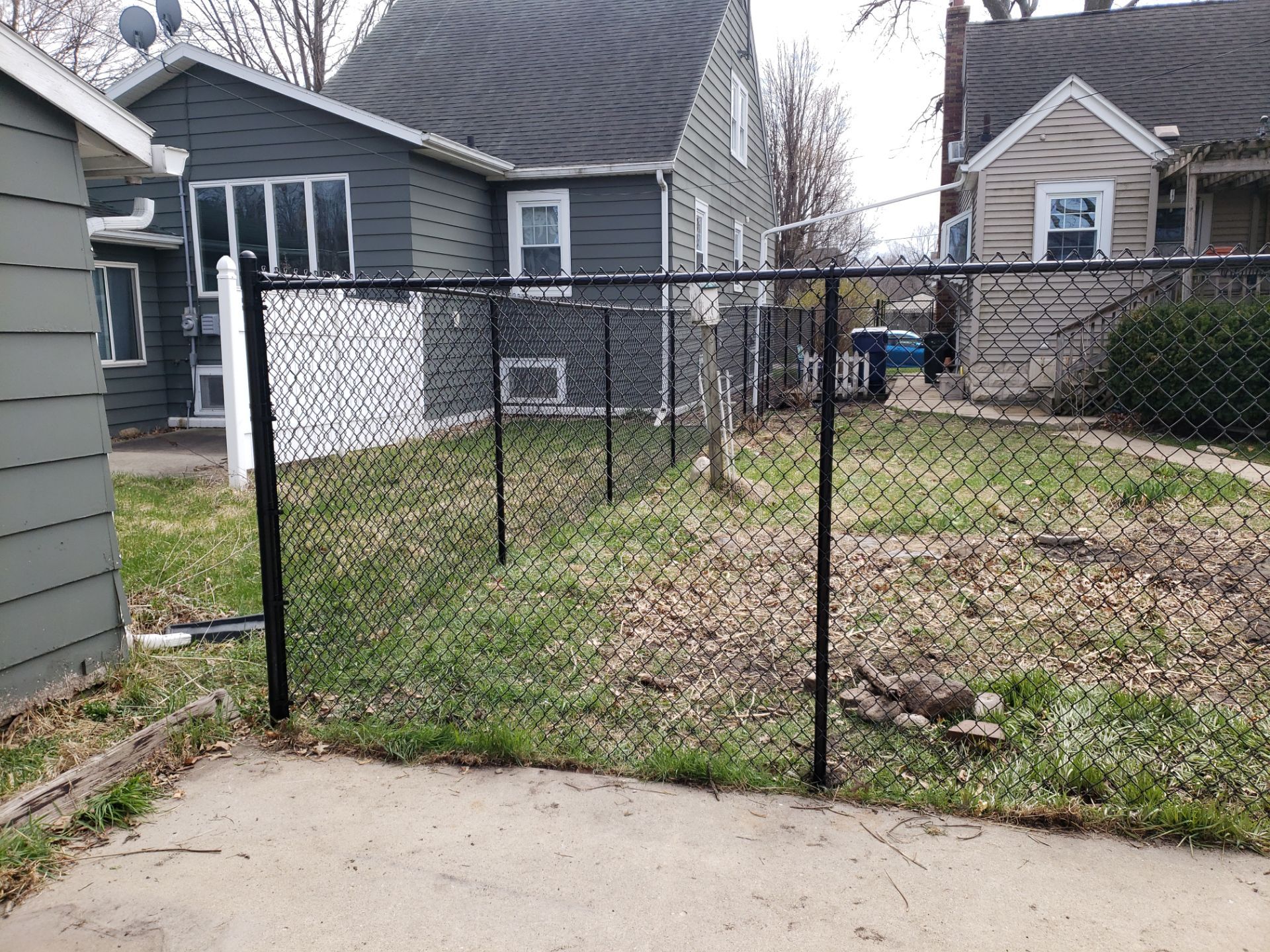 Black Vinyl Coated Chain Link Fence Installation in Waterloo by Perfect Picket Fence and Stain