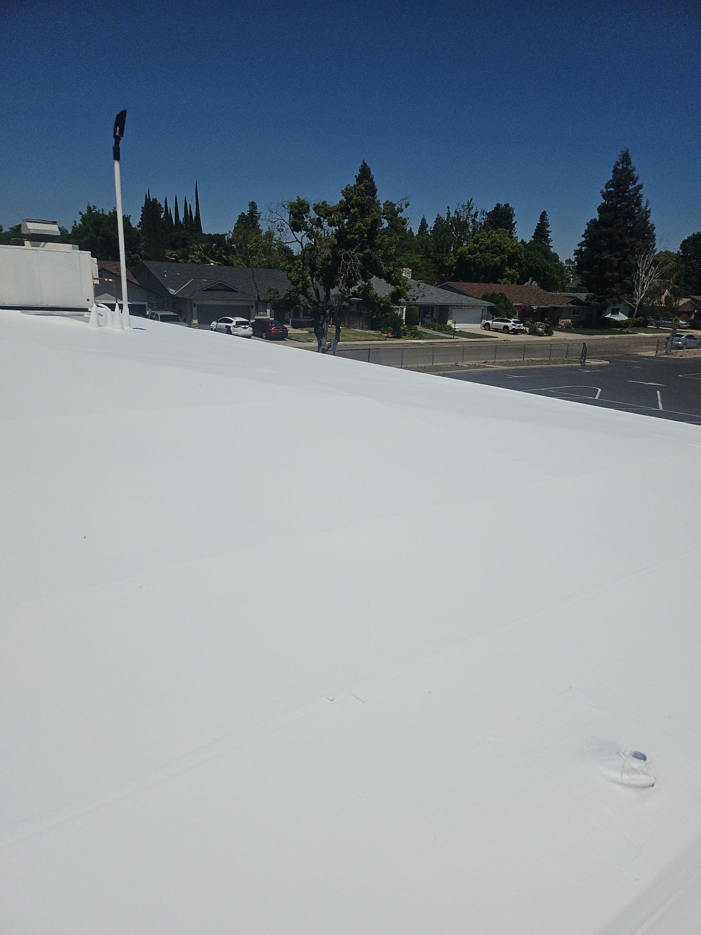 Single-ply restoration system using Benchmark/PUMA XL coatings over TPO single-ply roofing by Straight Edge Roofing Inc