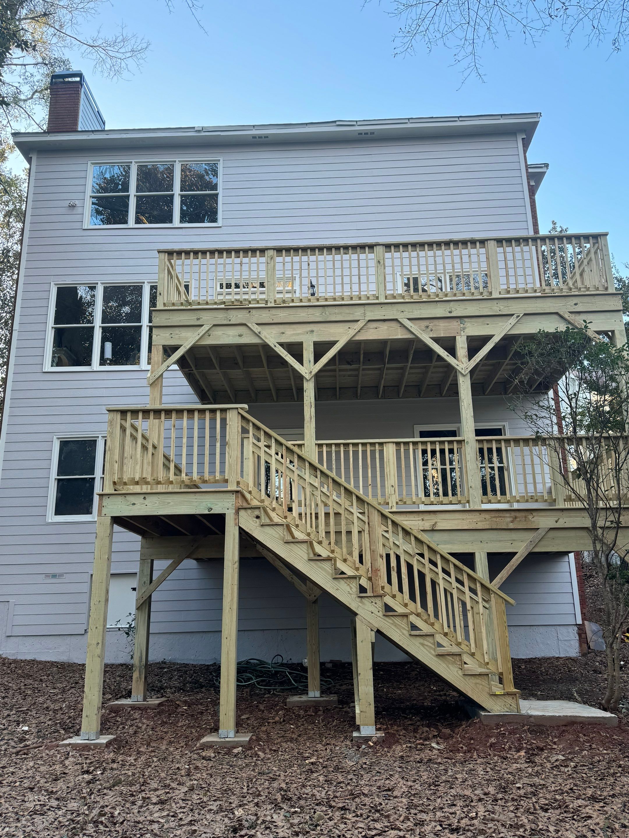 Multi-Level Pressure-Treated Wooden Deck Construction in Decatur by Swift Home Renovations