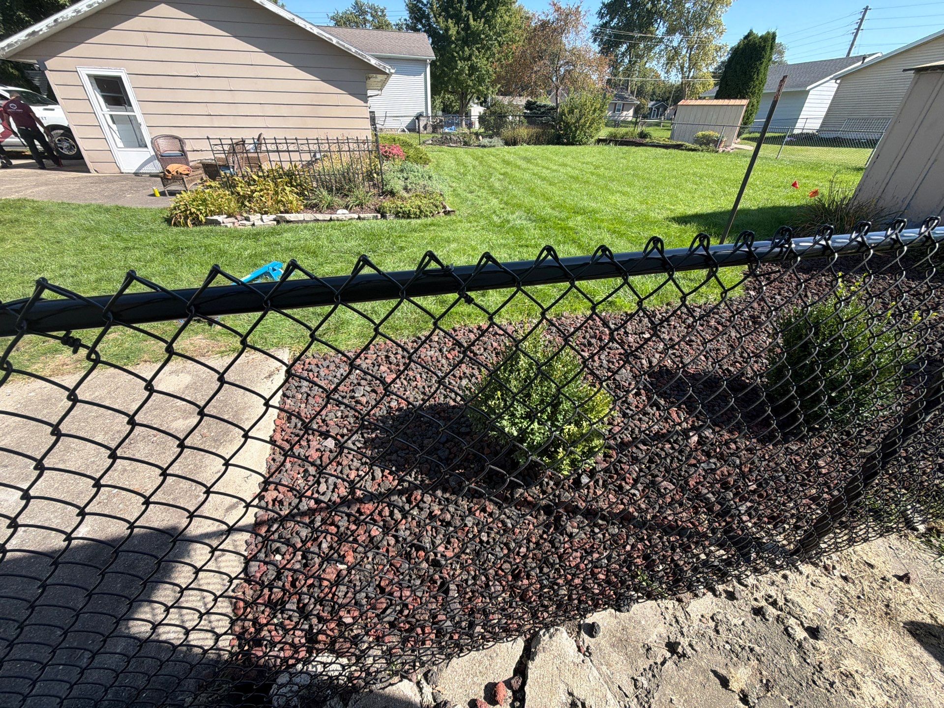Custom Vinyl Privacy and Black Chain Link Fence Installation in Cedar Falls by Perfect Picket Fence and Stain