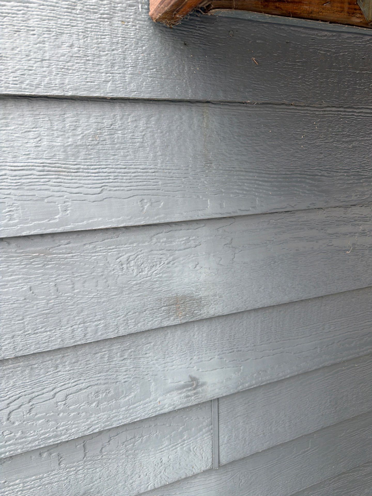 Madison Exterior Remodel with Dark Gray Siding and Stone Accents by Select Painting, Coatings & Garage Cabinets