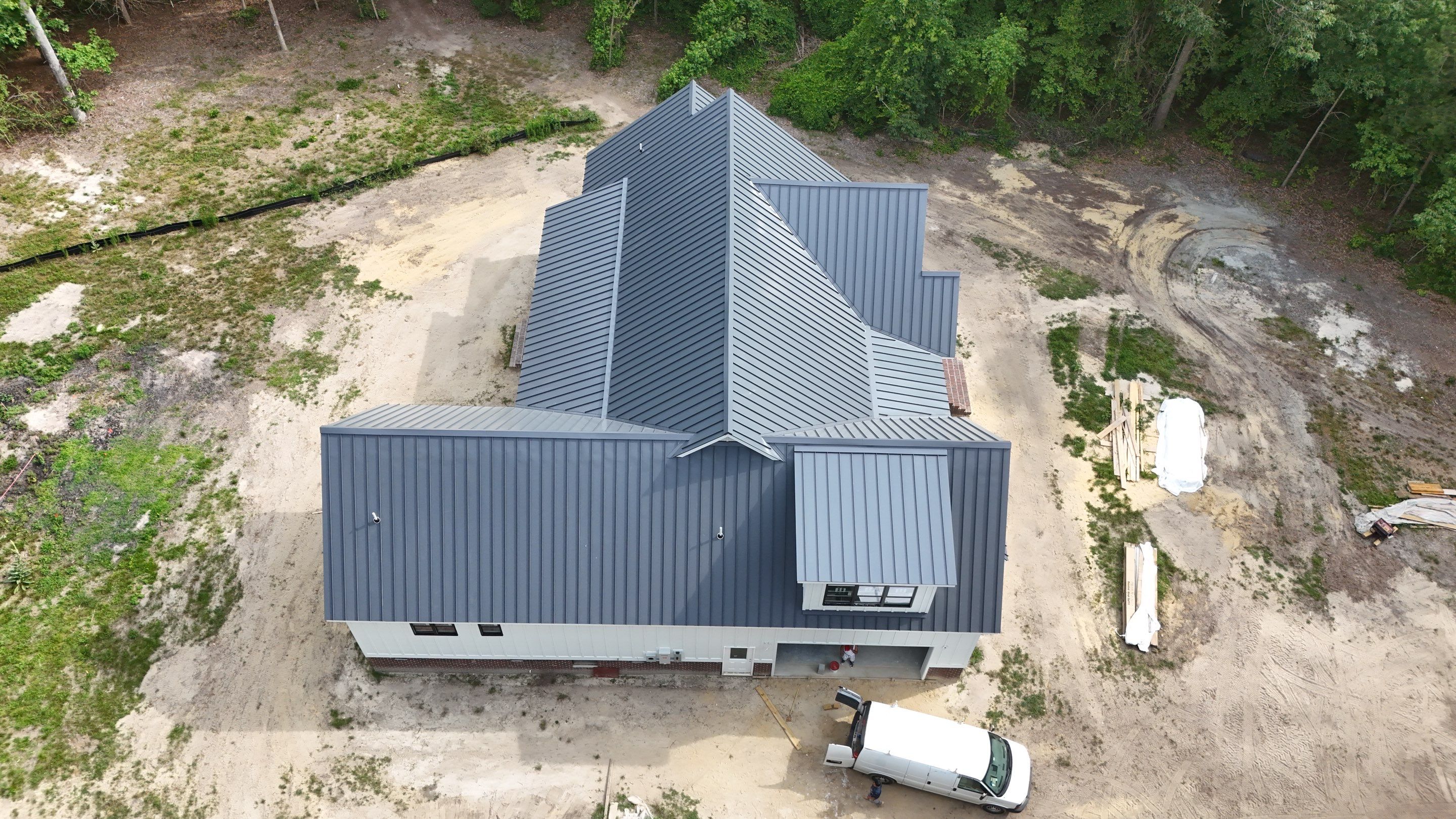 Custom New Construction Home Featuring Standing Seam Metal Roofing in Port Haywood by Cade Construction