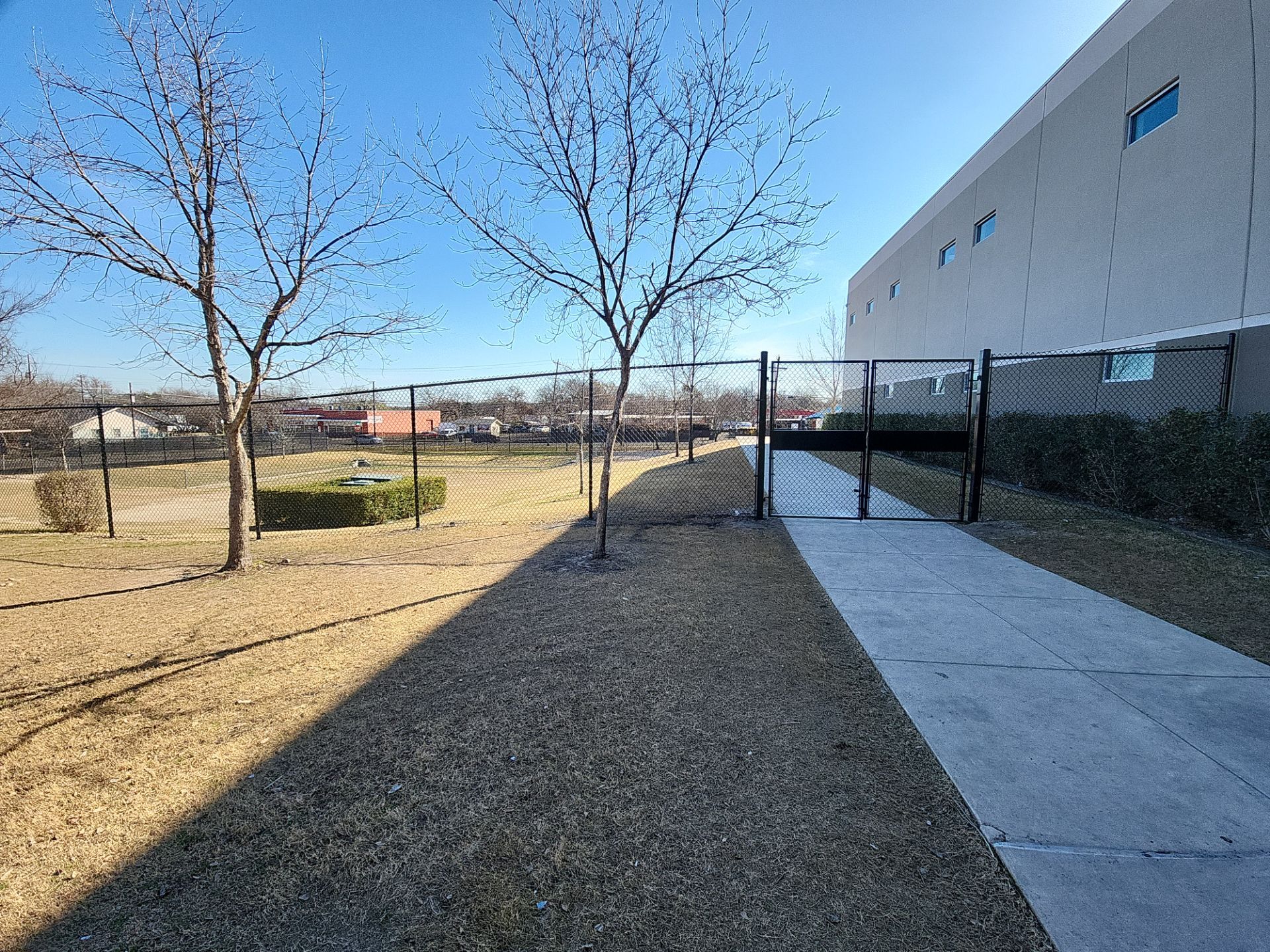 Commercial Fencing - Black vinyl coated Chain link Fence by 3:16 Roofing and Construction