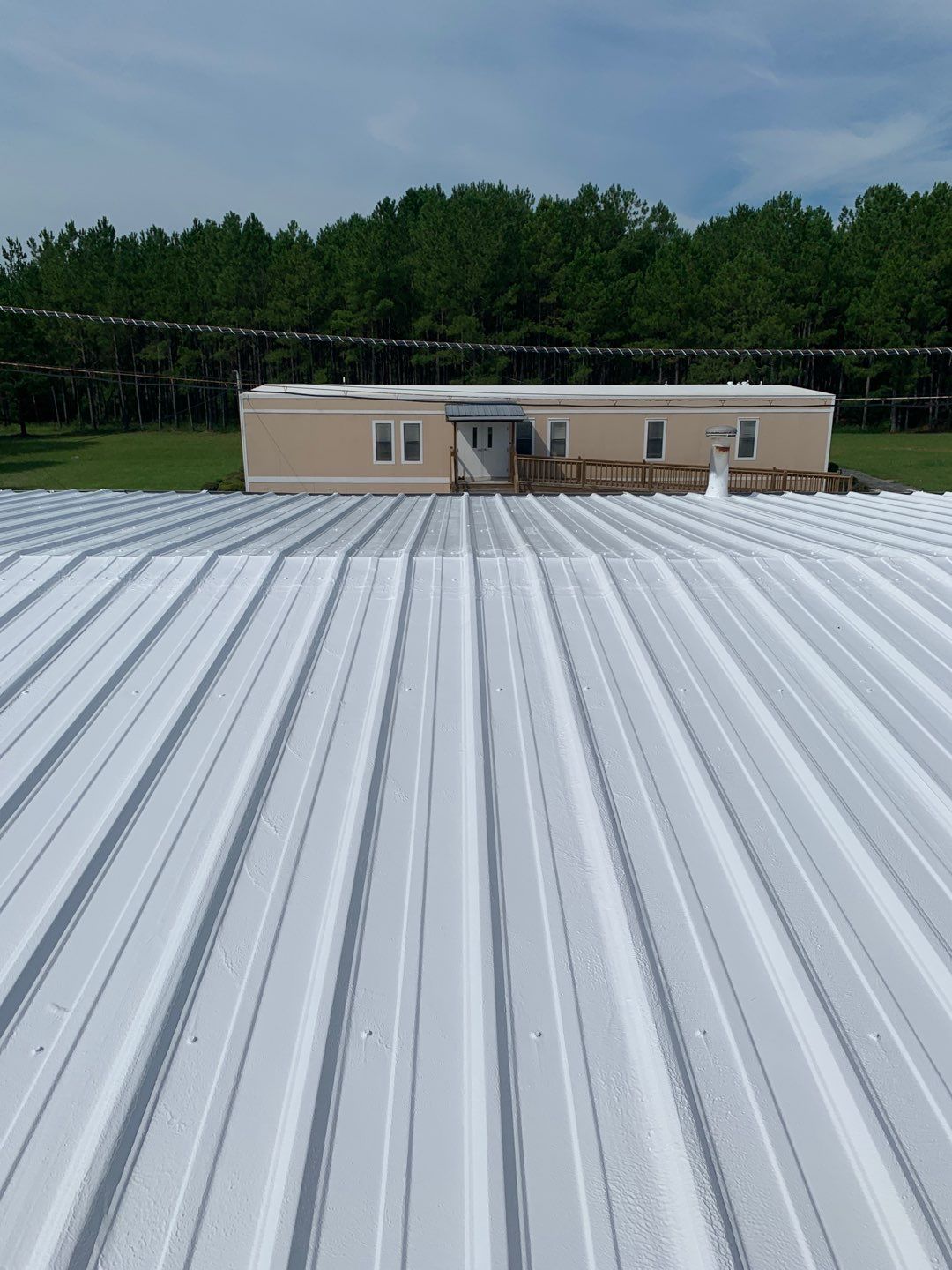 Aluminum roofing panels being installed on a commercial building in Andersonville, GA