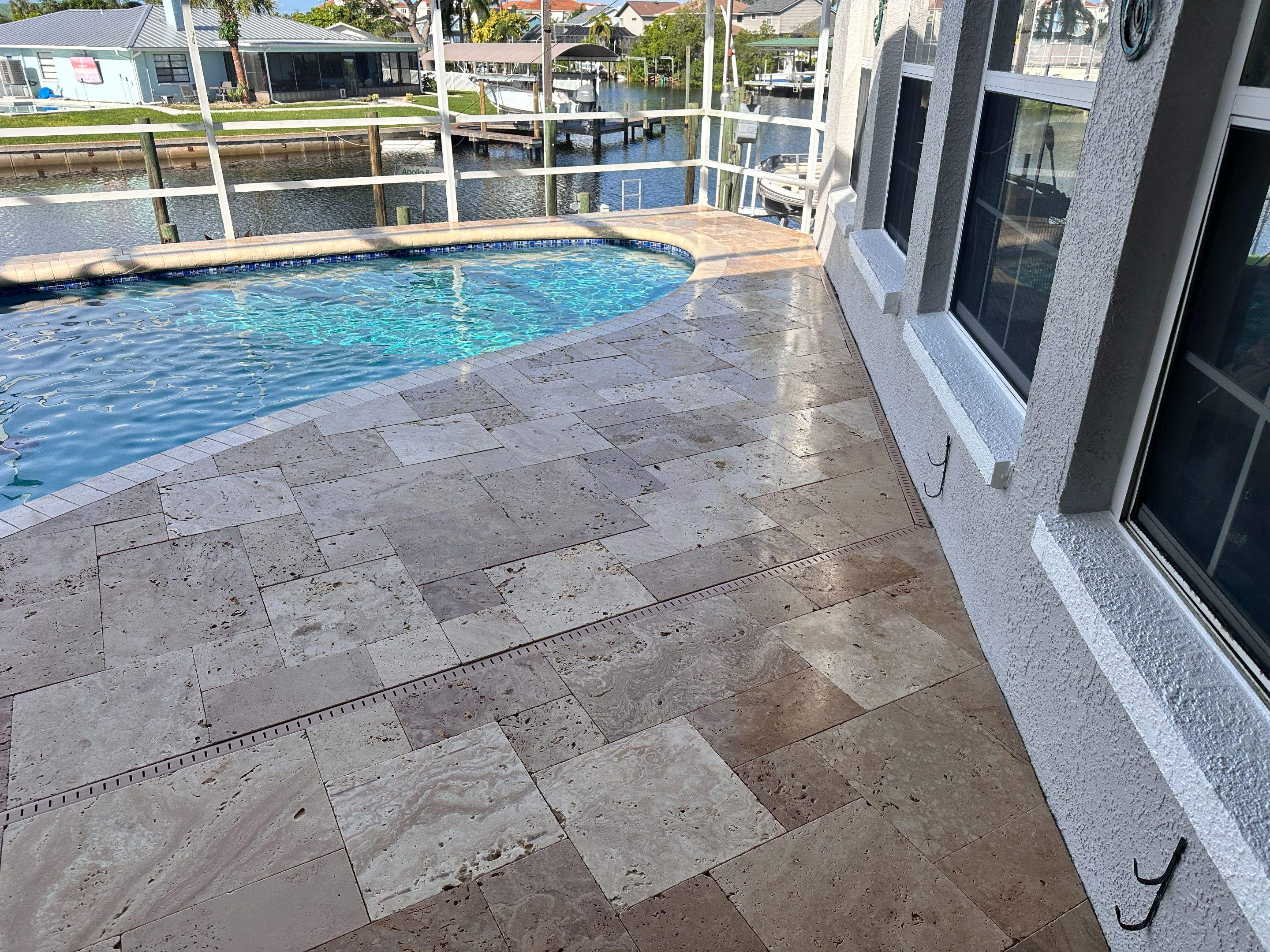 Travertine Sealing and Stripping for a Waterfront Pool Deck in Apollo Beach by Supreme Paver Experts