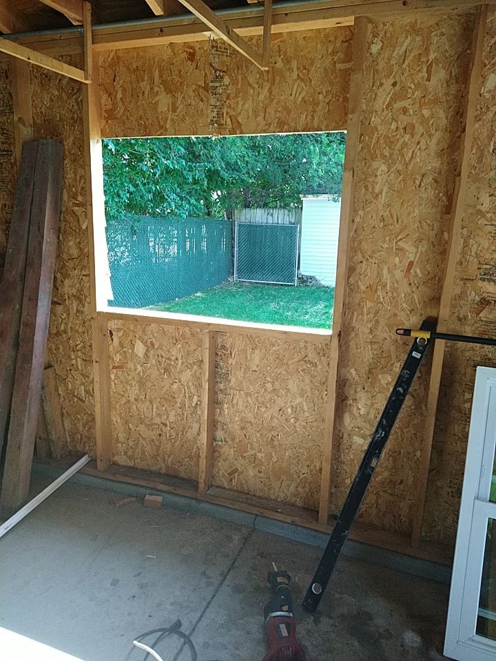 Siding Installation using Norandex woodsman dl-5 white woodgrain vinyl by Absolute Roofing and Construction
