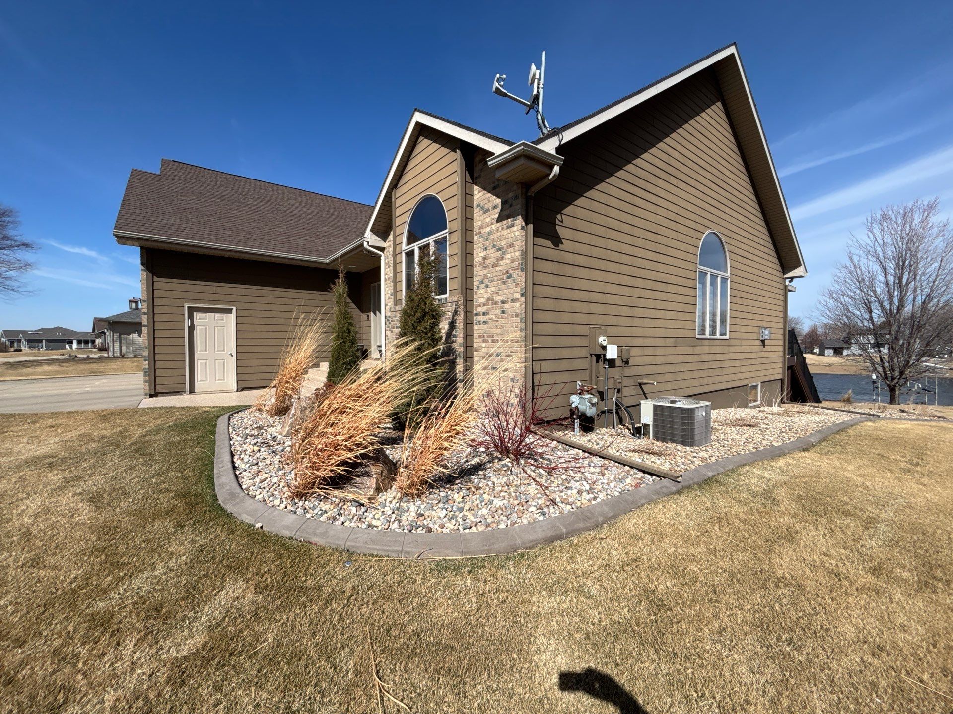 Full Exterior Renovation with Stone Veneer and Composite Decking by Select Painting, Coatings & Garage Cabinets