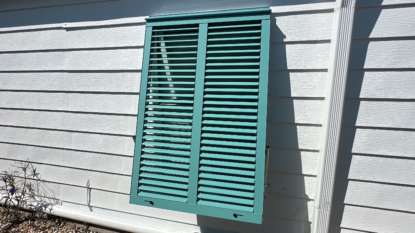 Hurricane Rated Bahama Shutters in Pastel Turquoise by Smart Guard Shutters