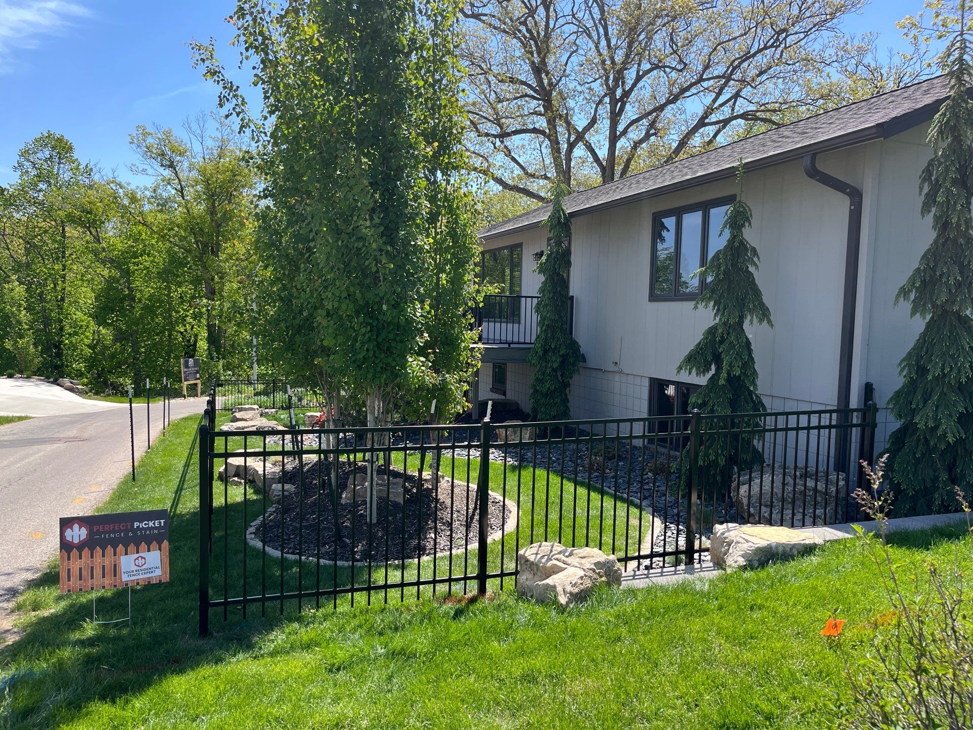 Ornamental Black Metal Picket Fence Installation in Cedar Falls by Perfect Picket Fence and Stain