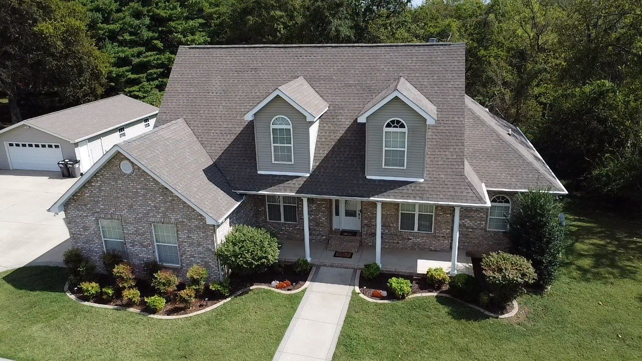 Roof and Gutter System Replacement with Stone Chimney Rebuild by Undersun Roofing 