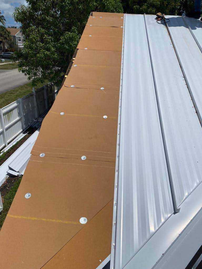 Standing Seam Metal & Flat Re-Roof using 1.5" Nail Strip 24ga Solar White Kynar Coated Standing Seam Metal Panels by Morton Roofing, Inc.